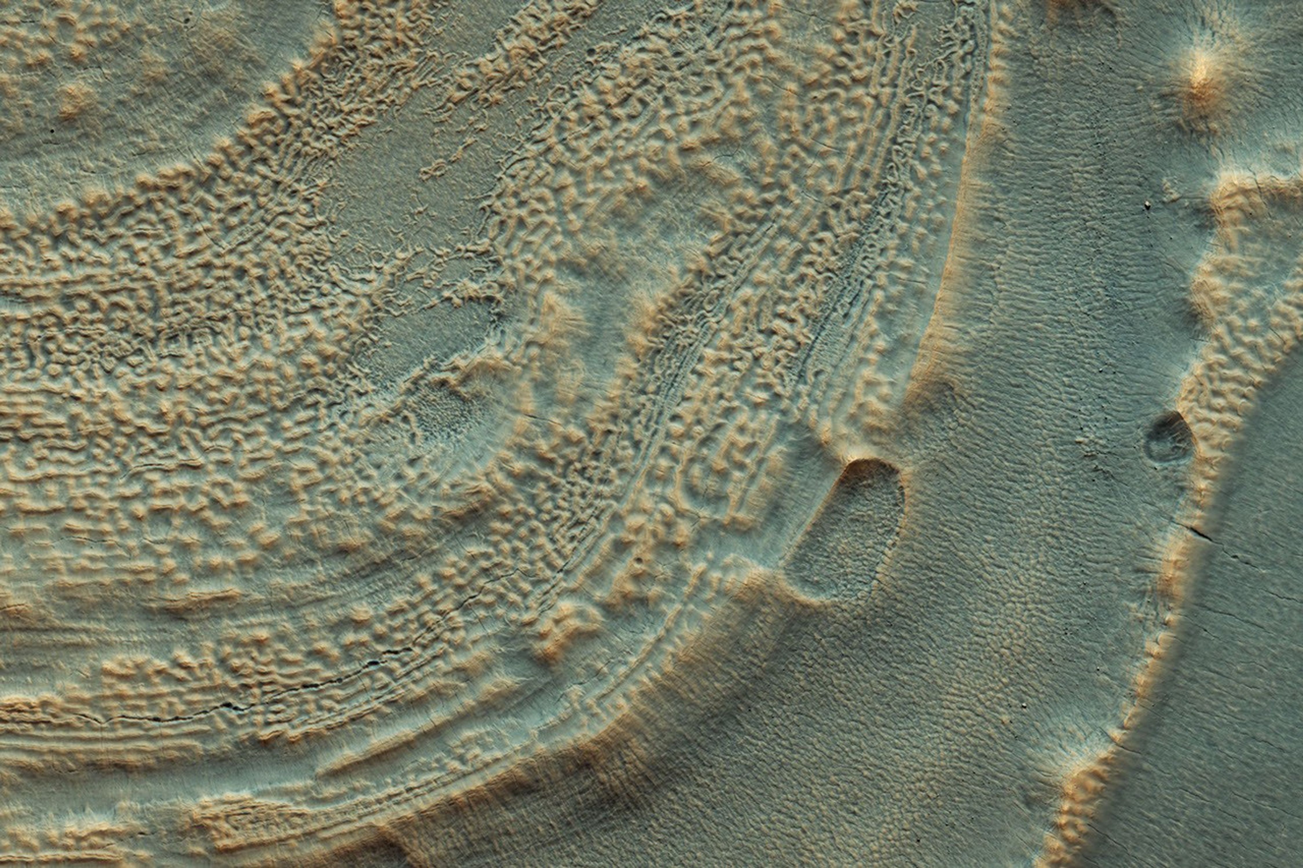 This image from NASA's Mars Reconnaissance Rover shows the edge of a mound of ice in one of the mid-latitude craters. Scientists now realize that ice is very common on the Martian surface.