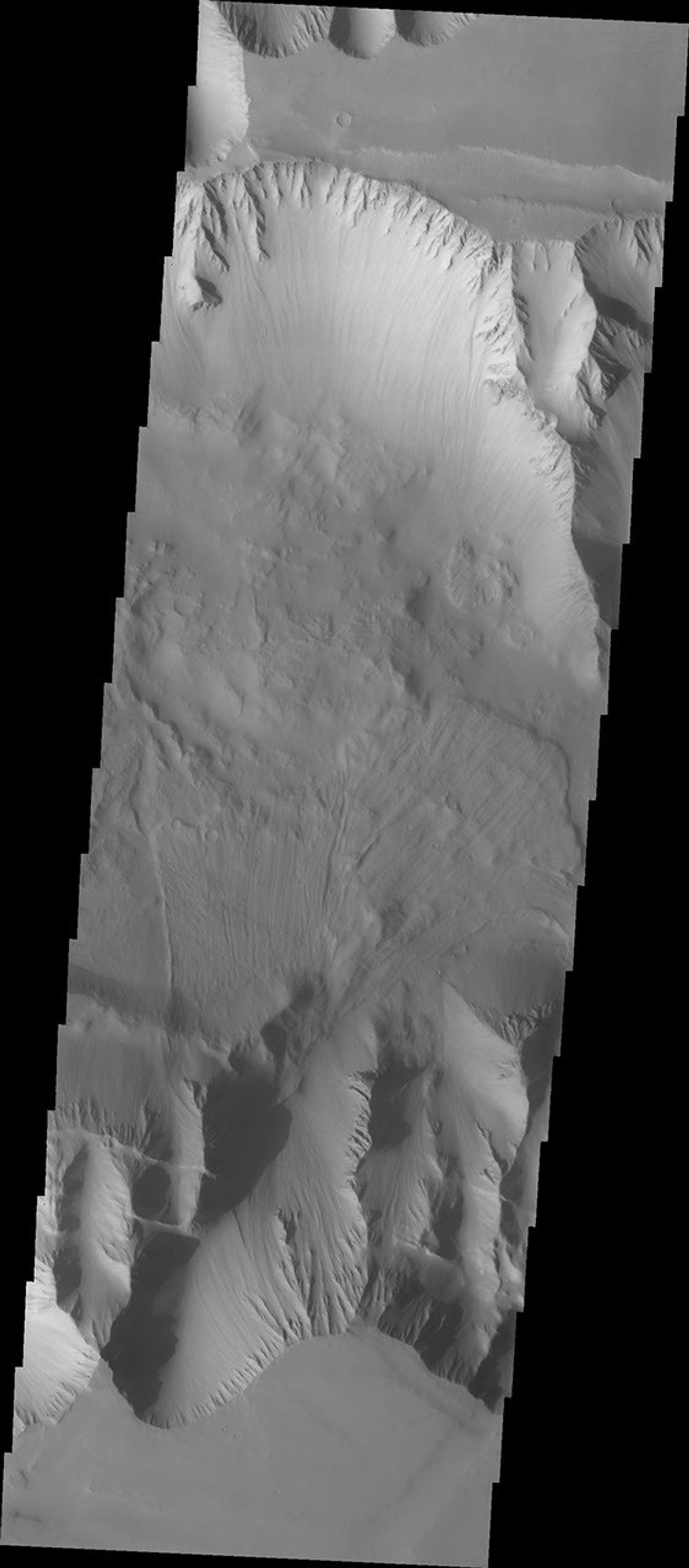 This image captured by NASA's 2001 Mars Odyssey spacecraft shows part of the western end of Ius Chasma. Both the north and south canyon walls are visible in this image. At the top of the frame paired faults have created a graben.