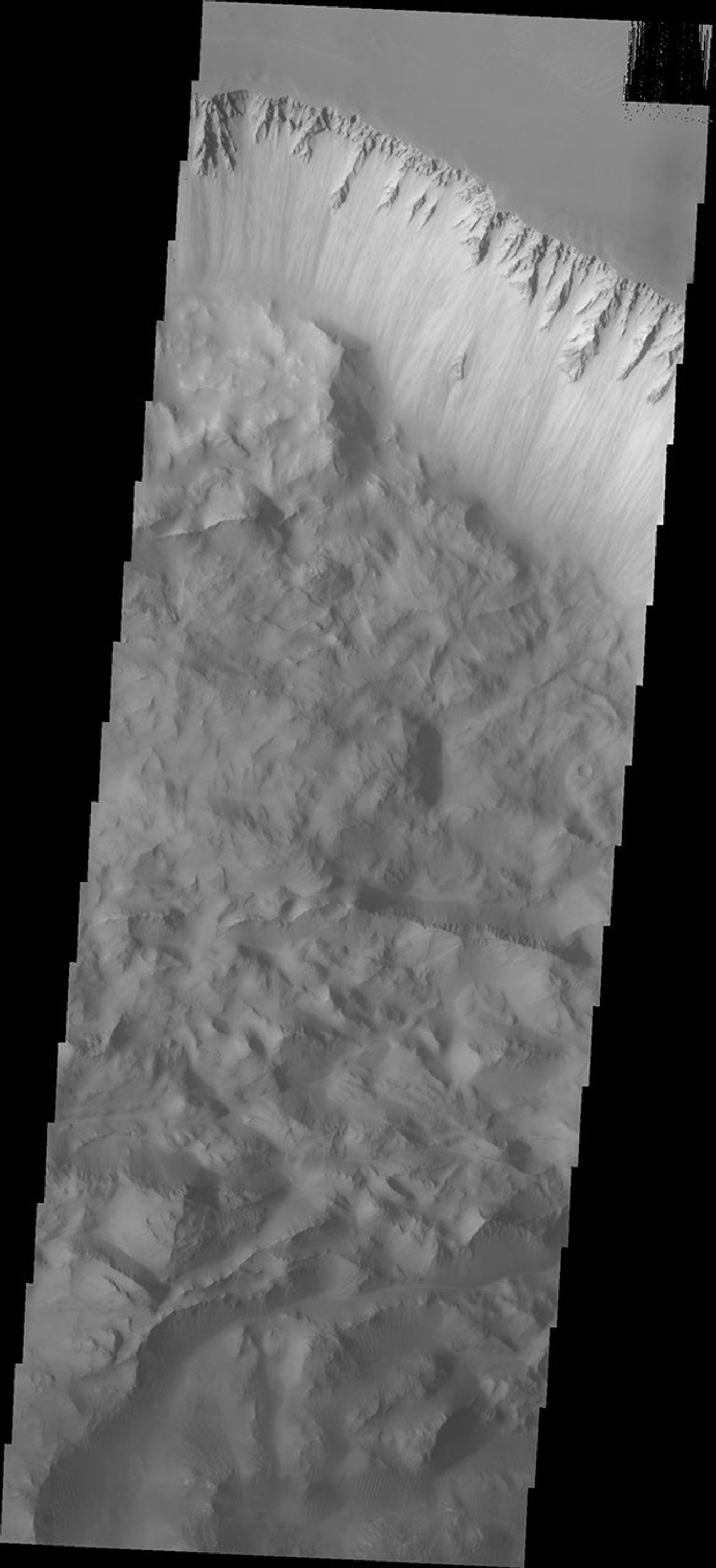 This image from NASA's 2001 Mars Odyssey spacecraft shows the eastern section of the large landslide deposit seen in Ius Chasma. A landslide is a failure of slope due to gravity.