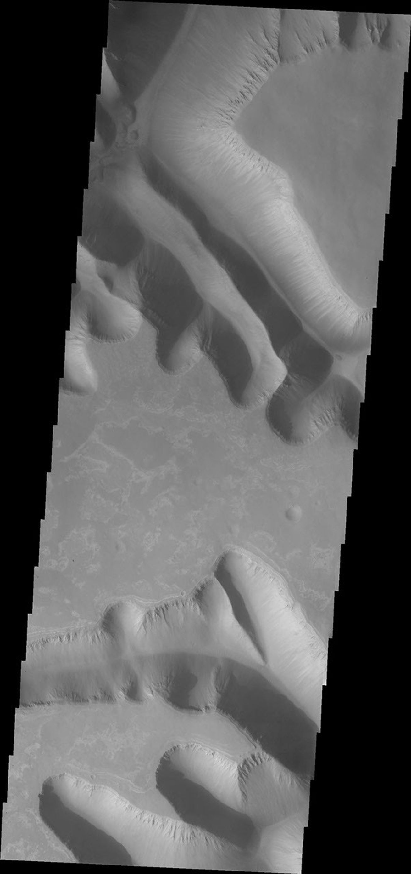 Ius Chasma is unique from the other chasmata of Valles Marineris in possessing mega gullies on both sides of the chasma. This image was captured by NASA's 2001 Mars Odyssey spacecraft.