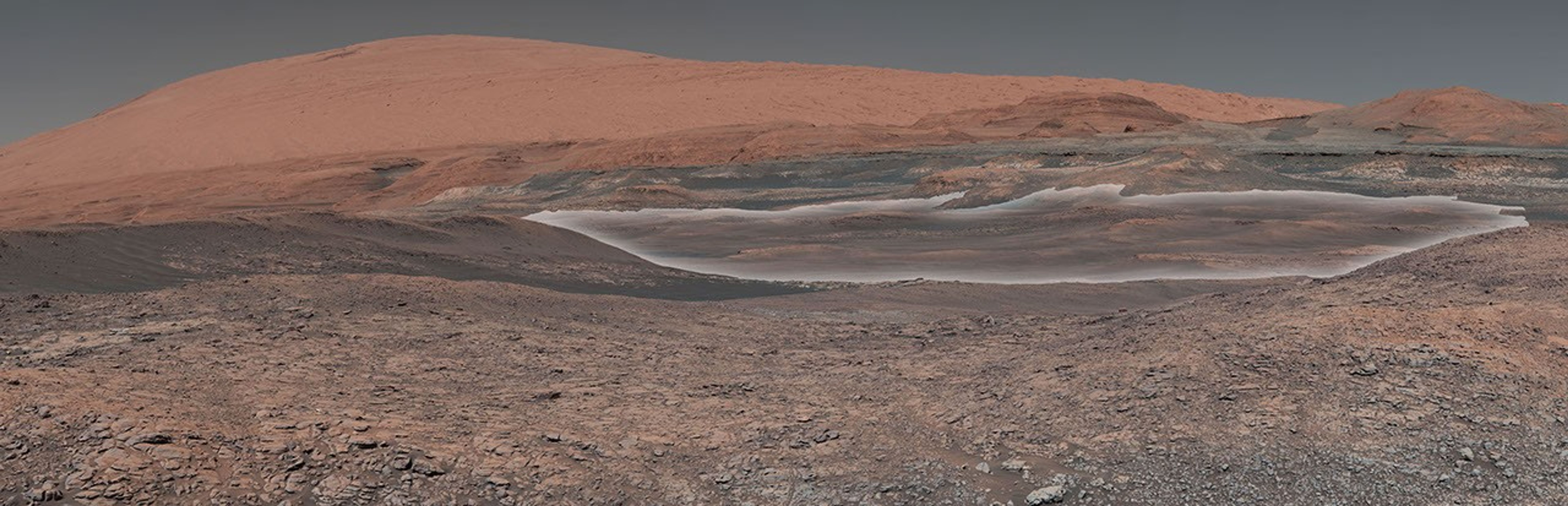 This mosaic taken by NASA's Mars Curiosity rover looks uphill at Mount Sharp. Highlighted is an area in white with clay-bearing rocks that scientists are eager to explore.