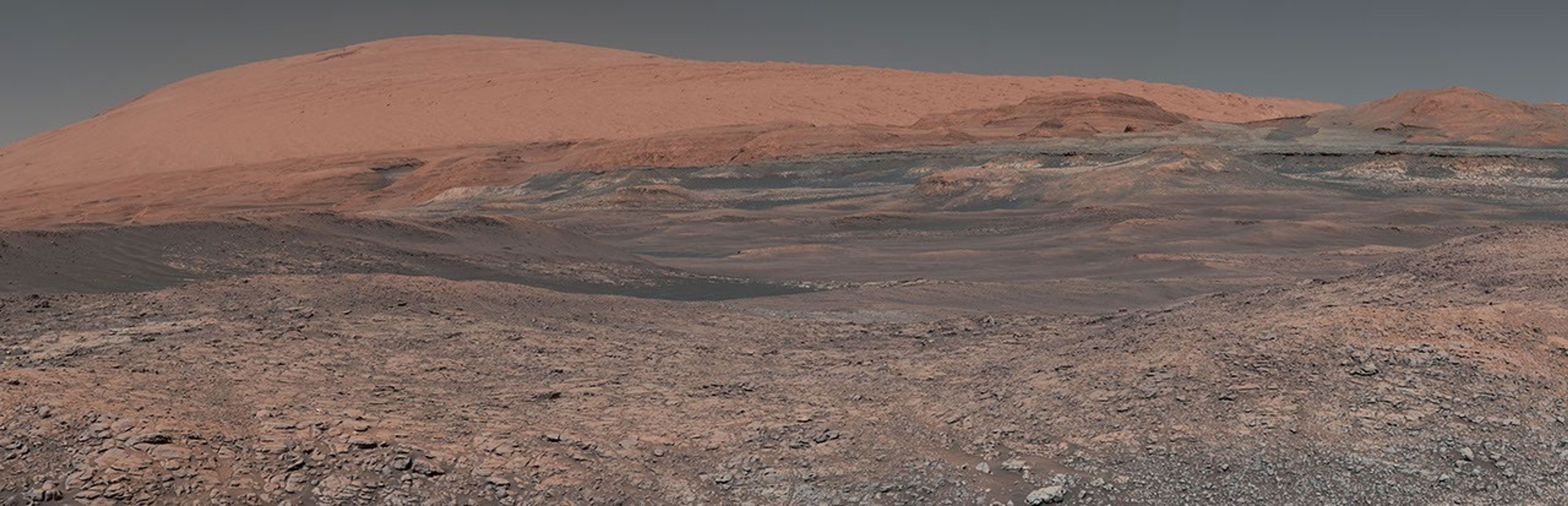 This mosaic taken by NASA's Mars Curiosity rover looks uphill at Mount Sharp. The scene has been white-balanced so the colors of the rock materials resemble how they would appear under daytime lighting conditions on Earth.