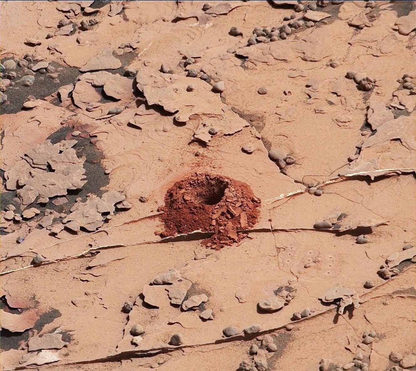 A close-up image of a 2-inch-deep hole produced using a new drilling technique for NASA's Curiosity rover. Curiosity drilled this hole in a target called 'Duluth' on May 20, 2018.