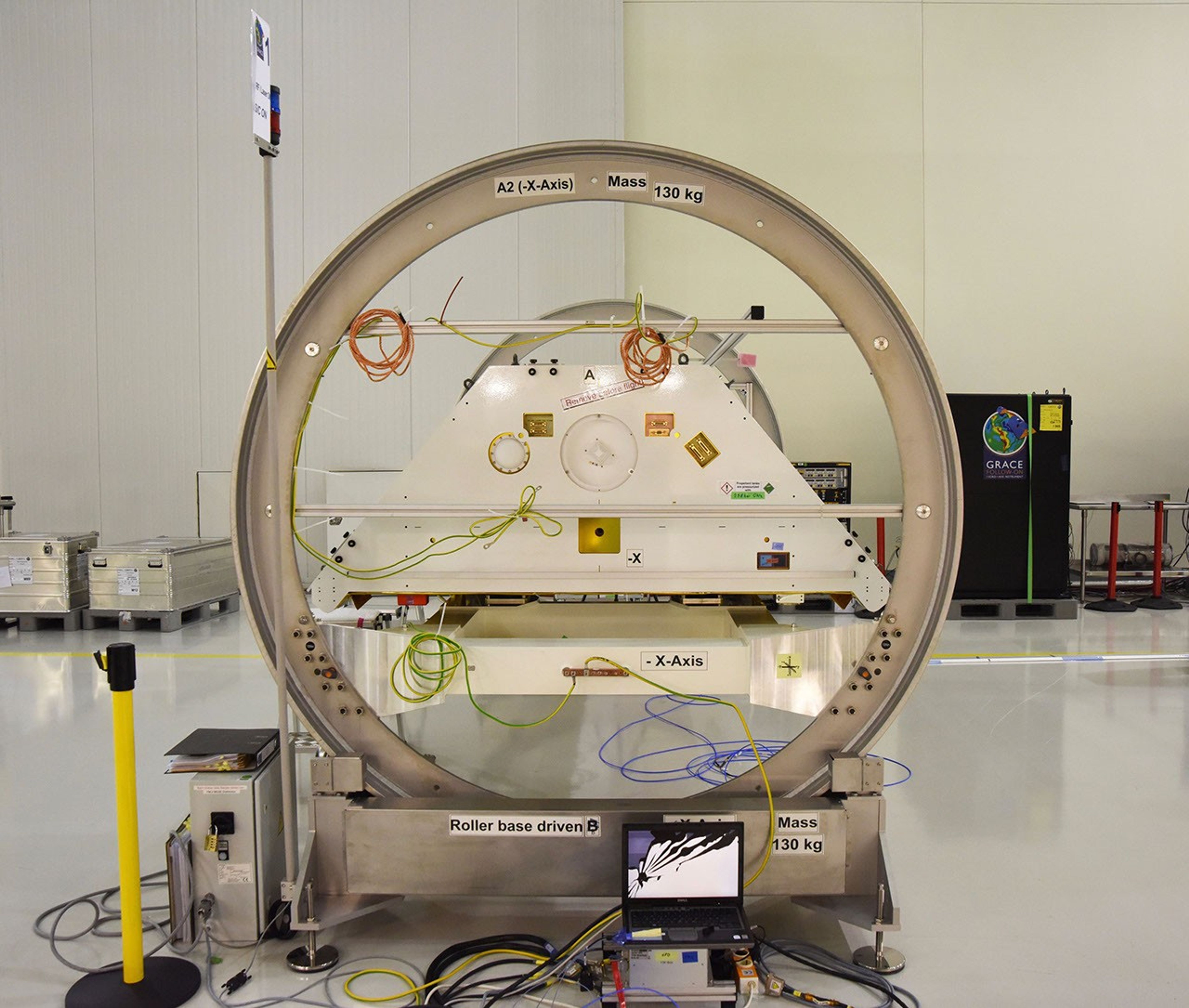 One of the two Gravity Recovery and Climate Experiment Follow-On (GRACE-FO) satellites and its turntable fixture at the Astrotech Space Operations processing facility at Vandenberg Air Force Base, California.