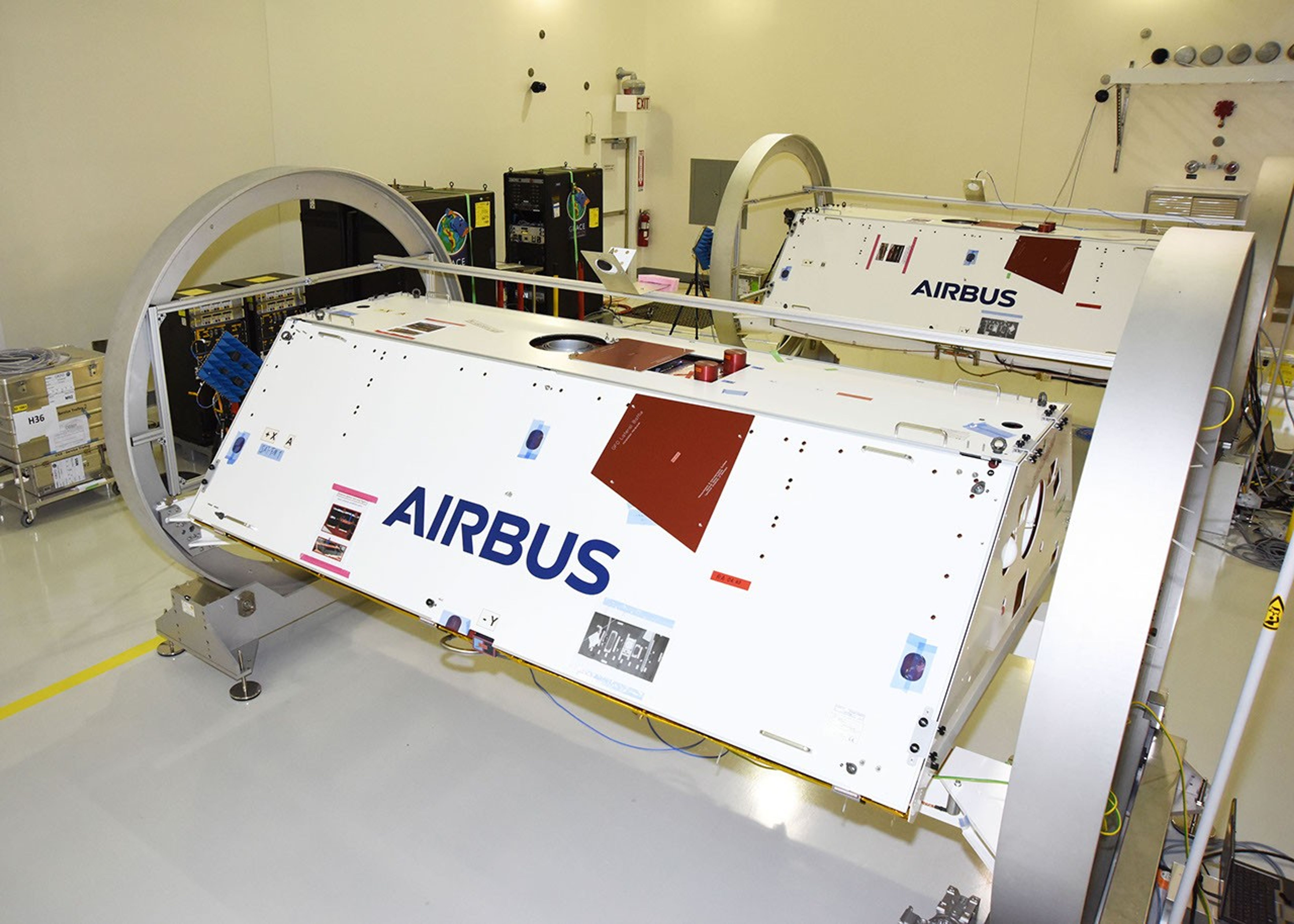 The Gravity Recovery and Climate Experiment Follow-On (GRACE-FO) twin satellites, attached to turntable fixtures, at the Astrotech Space Operations processing facility at Vandenberg Air Force Base, California.