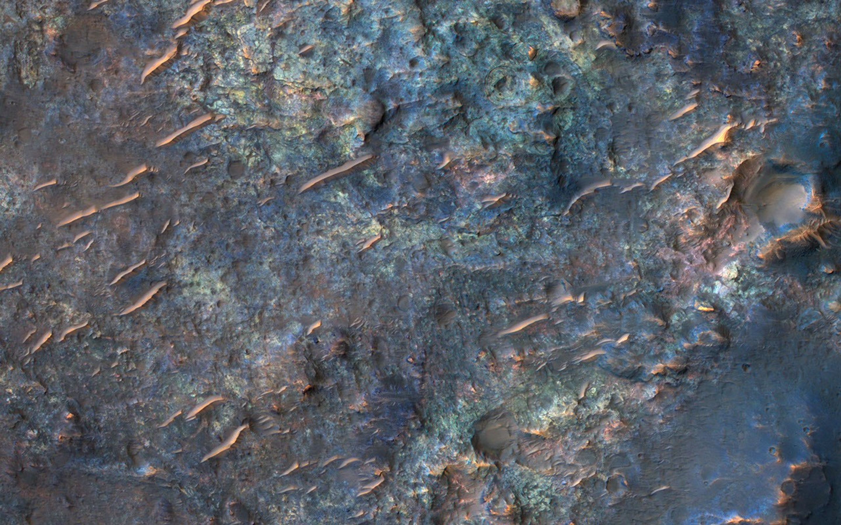 This image from NASA's Mars Reconnaissance Orbiter (MRO) shows bedrock units with diverse colors indicating different mineral concentrations.