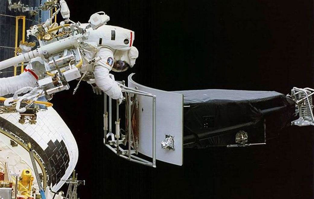 This image of NASA's Hubble Space Telescope shows Astronaut Jeffrey Hoffman removing the Wide Field and Planetary Camera 1 (WFPC 1) during the first Hubble servicing mission (SM1), which took place in December, 1993.