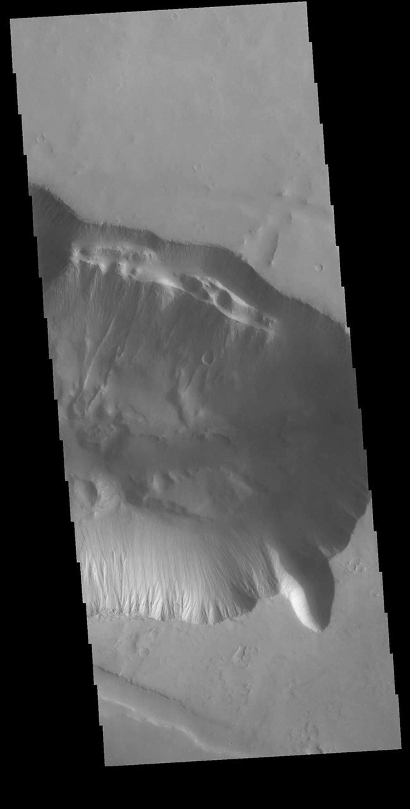 This image from NASA's Mars Odyssey shows the eastern edge of Tithonium Chasma, one of the large valley systems that comprise Valles Marineris. Large fractures are visible on the upper margin of the chasma.