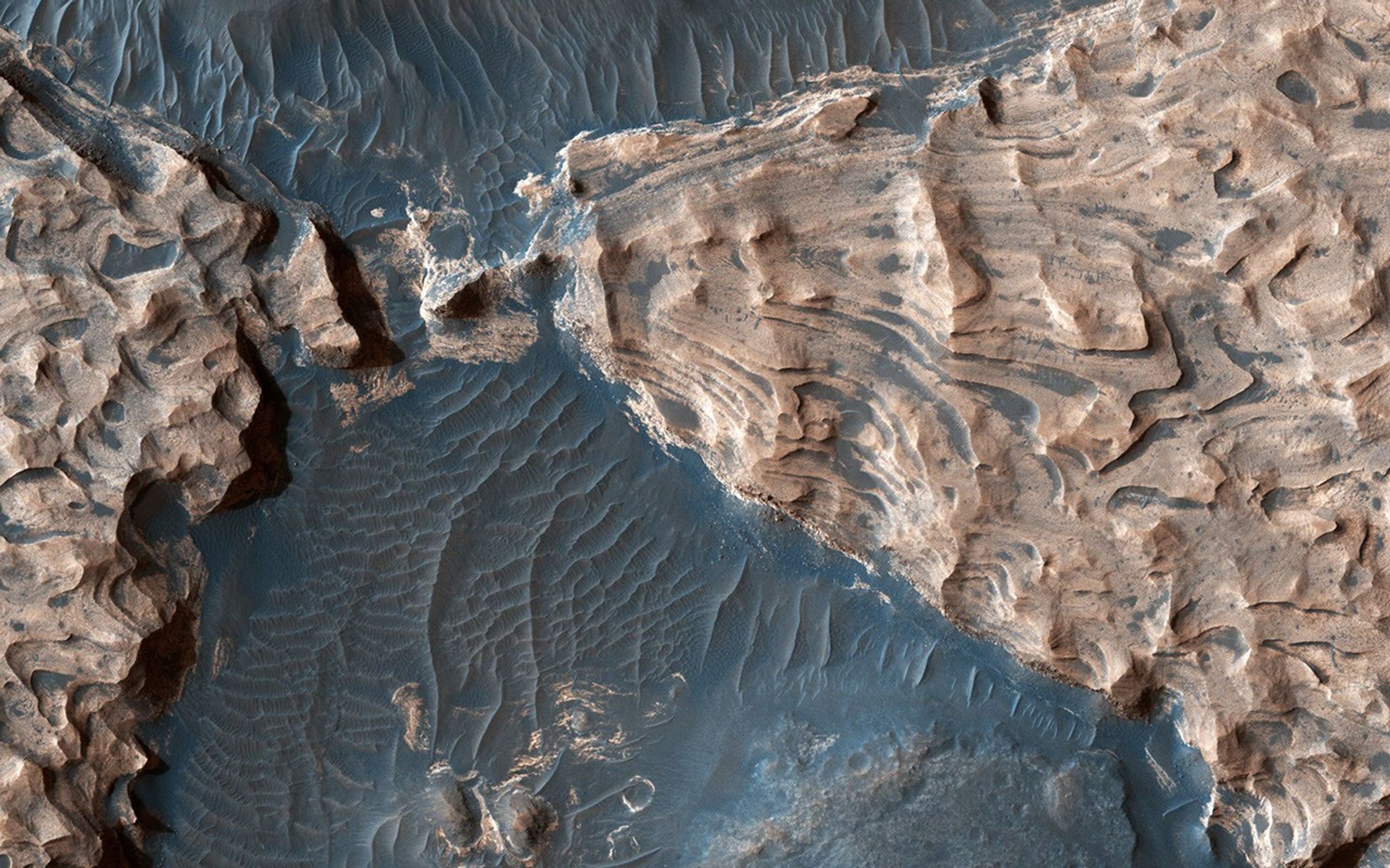 This image from NASA's Mars Reconnaissance Orbiter shows Aram Chaos, an ancient impact crater that lies within in the Southern Highlands of Mars. Uplifted blocks are composed largely of the iron-oxide hematite and water-altered silicates.