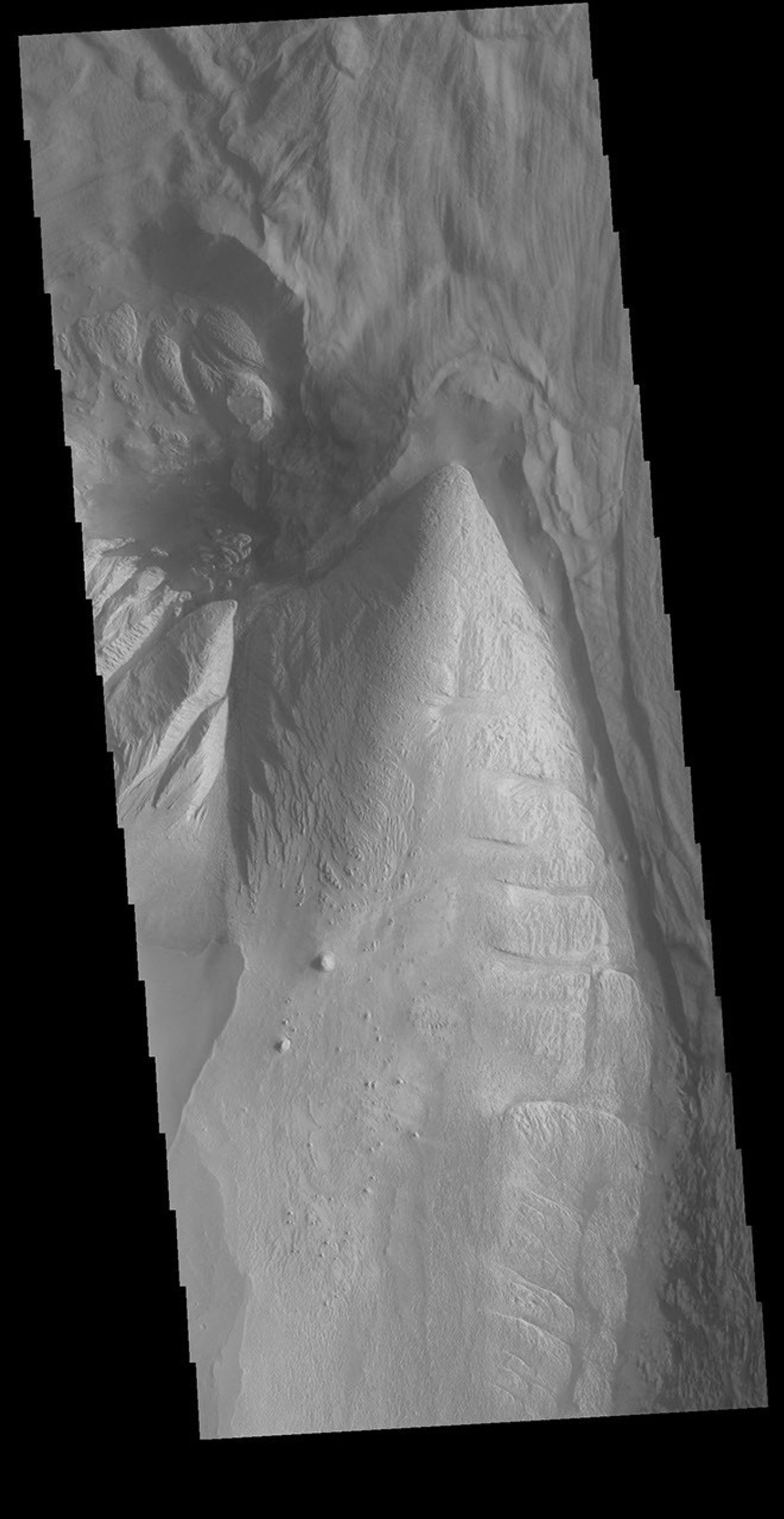 This image from NASA's Mars Odyssey shows a portion of Ophir Chasma, a part of Valles Marineris, the largest canyon system on Mars. At the top of the image is a portion of a large landslide deposit which originate at the northern wall of the canyon.