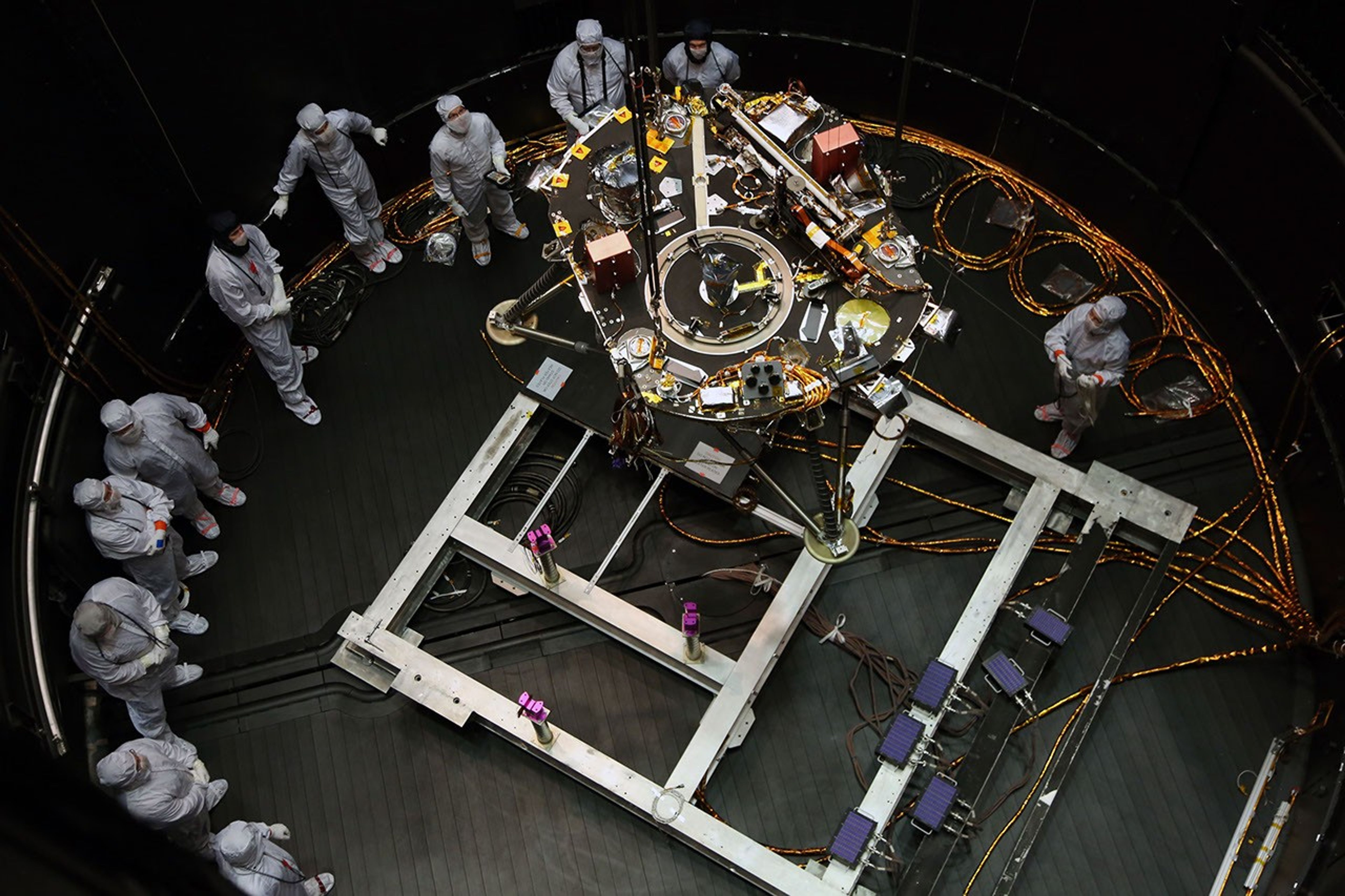 Engineers at Lockheed Martin Space, Denver, Colorado, prepare NASA's InSight lander for testing in a thermal vacuum chamber several months before launch.
