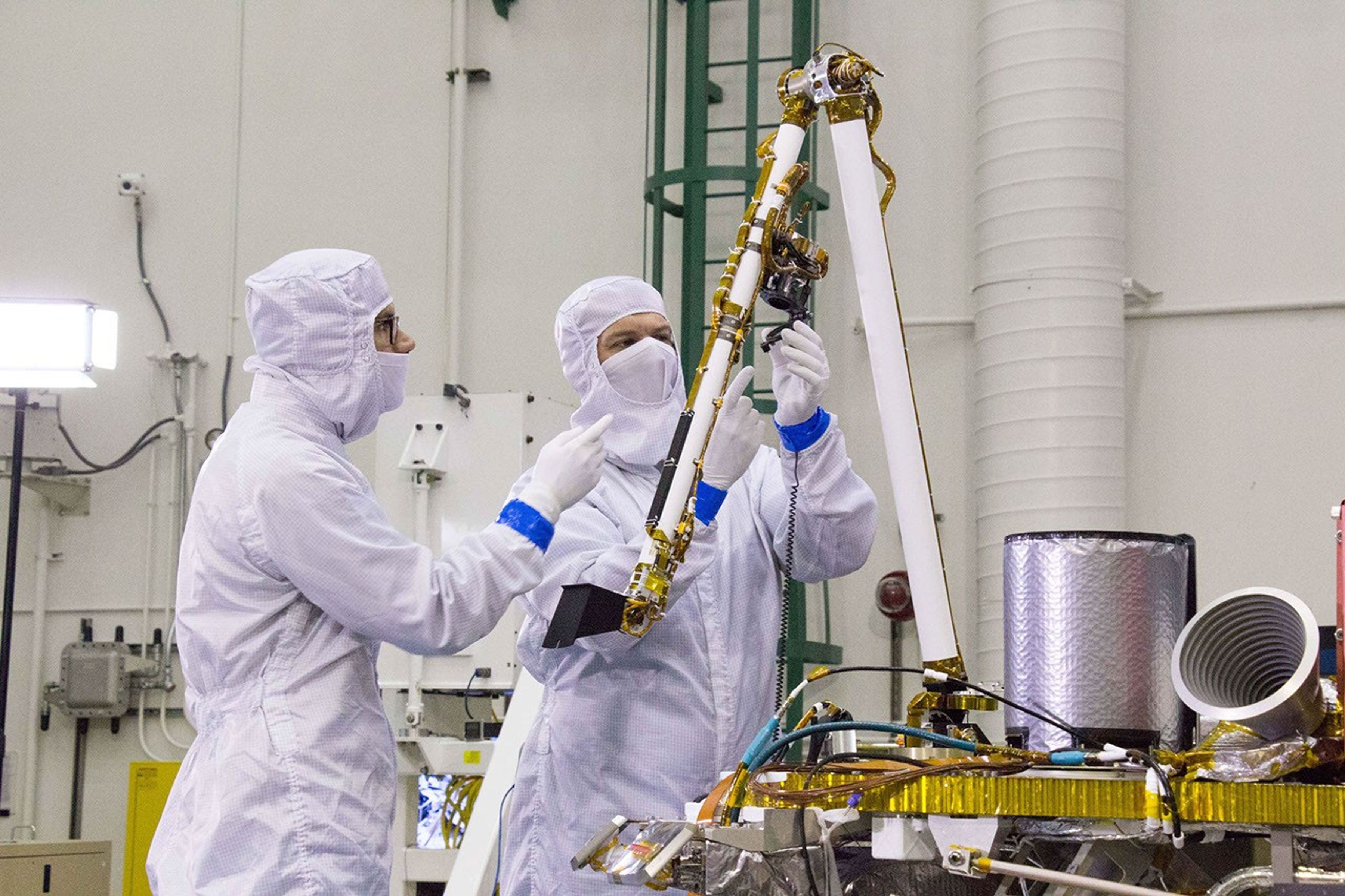 Engineers at Lockheed Martin Space, Denver, Colorado, test the robotic arm on NASA's InSight lander several months before launch.