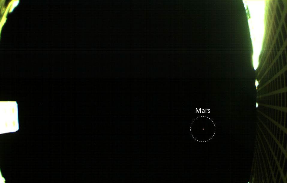 The is the first image of Mars captured by one of NASA's Mars Cube One (MarCO) CubeSats showing both the CubeSat's unfolded high-gain antenna at right and Mars just below, acquired by MarCO-B on October 2, 2018.