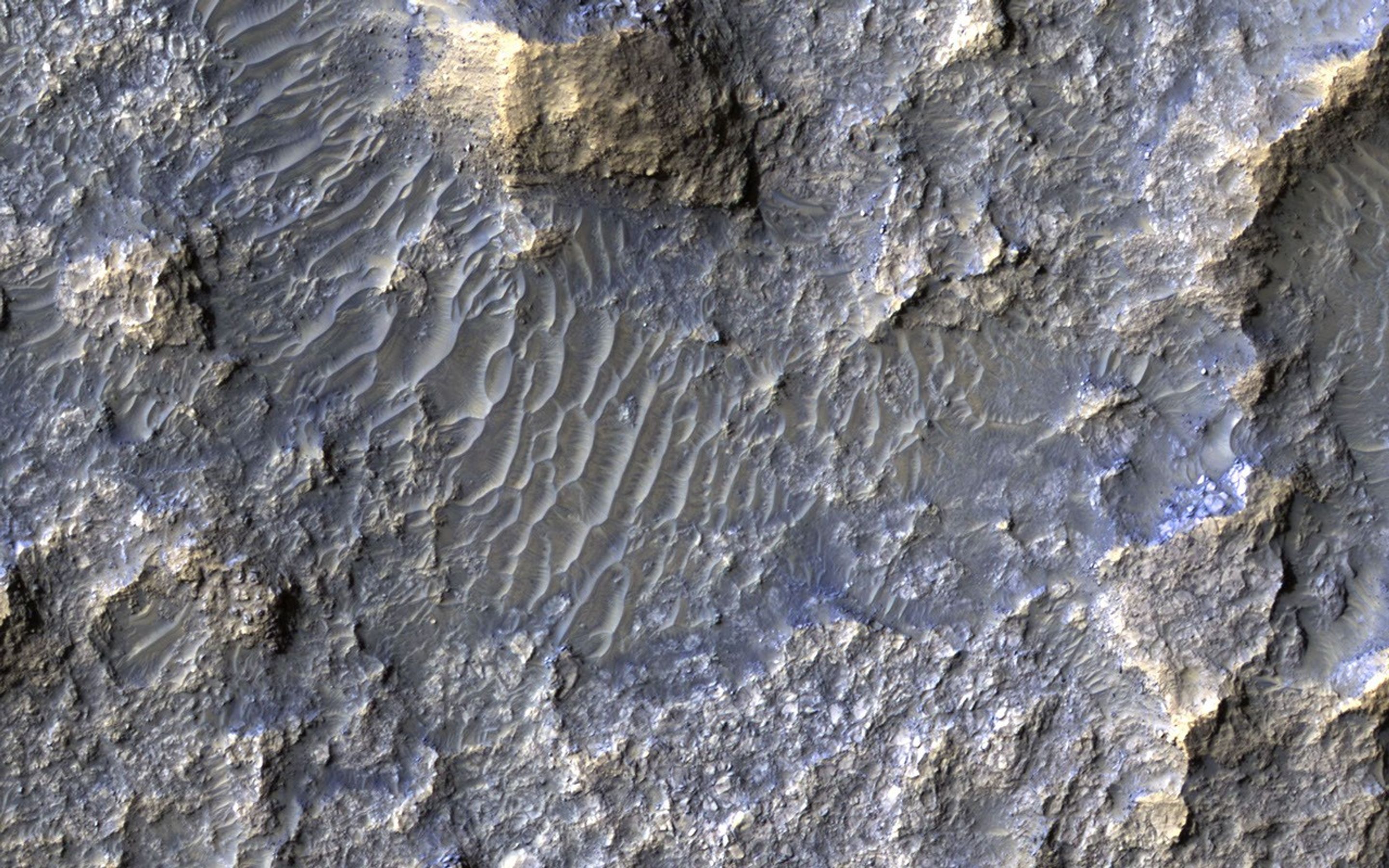 This image acquired on May 22, 2018 by NASA's Mars Reconnaissance Orbiter, shows a 30-kilometer diameter crater, filled-in with materials that created bedrock, and through subsequent erosion, wind-driven particles.