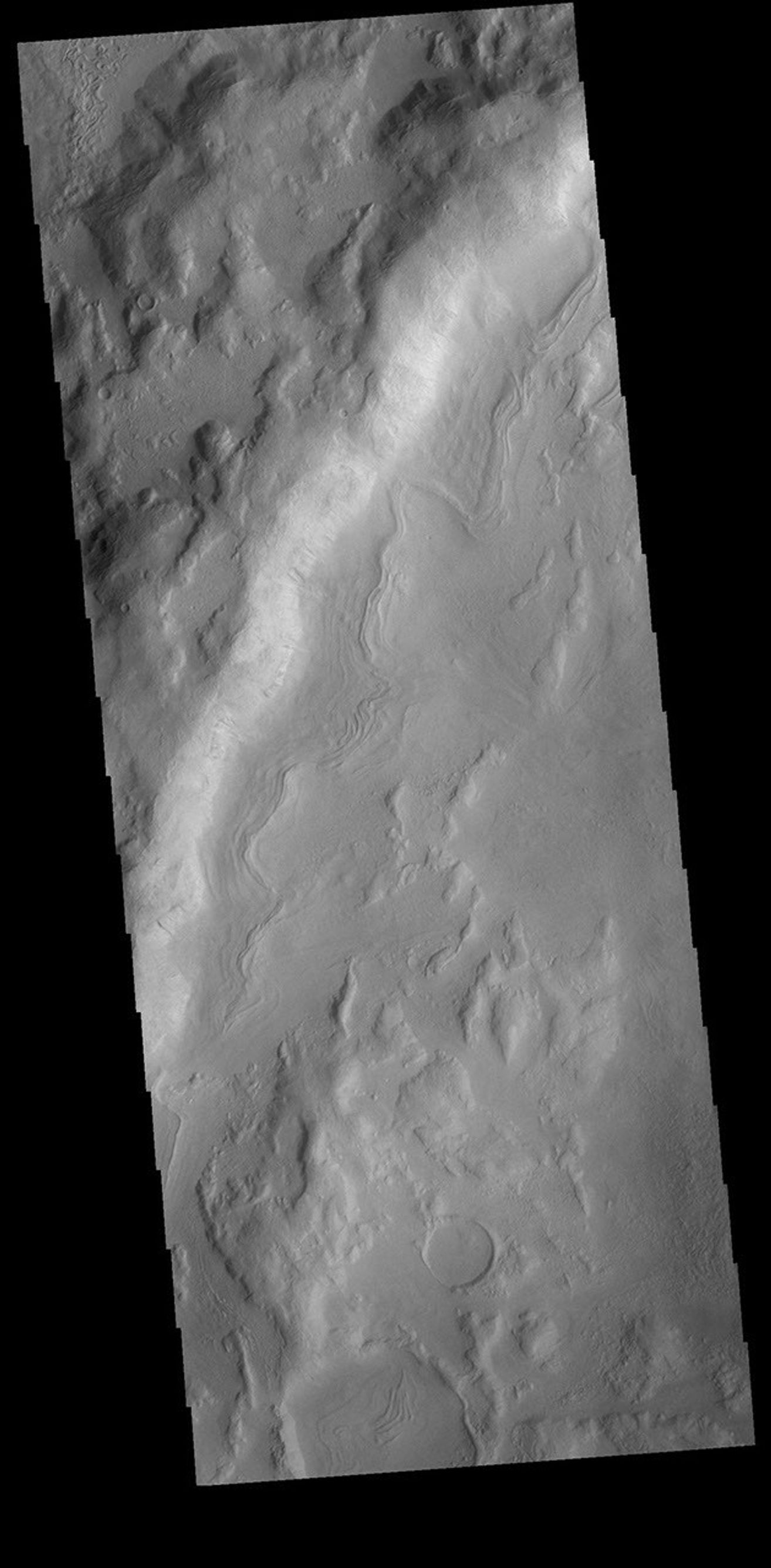 This image from NASA's Mars Odyssey shows an unnamed crater in Noachis Terra. The sinuous feature near the bottom of the crater rim appears to have been caused by down slope movement of materials.