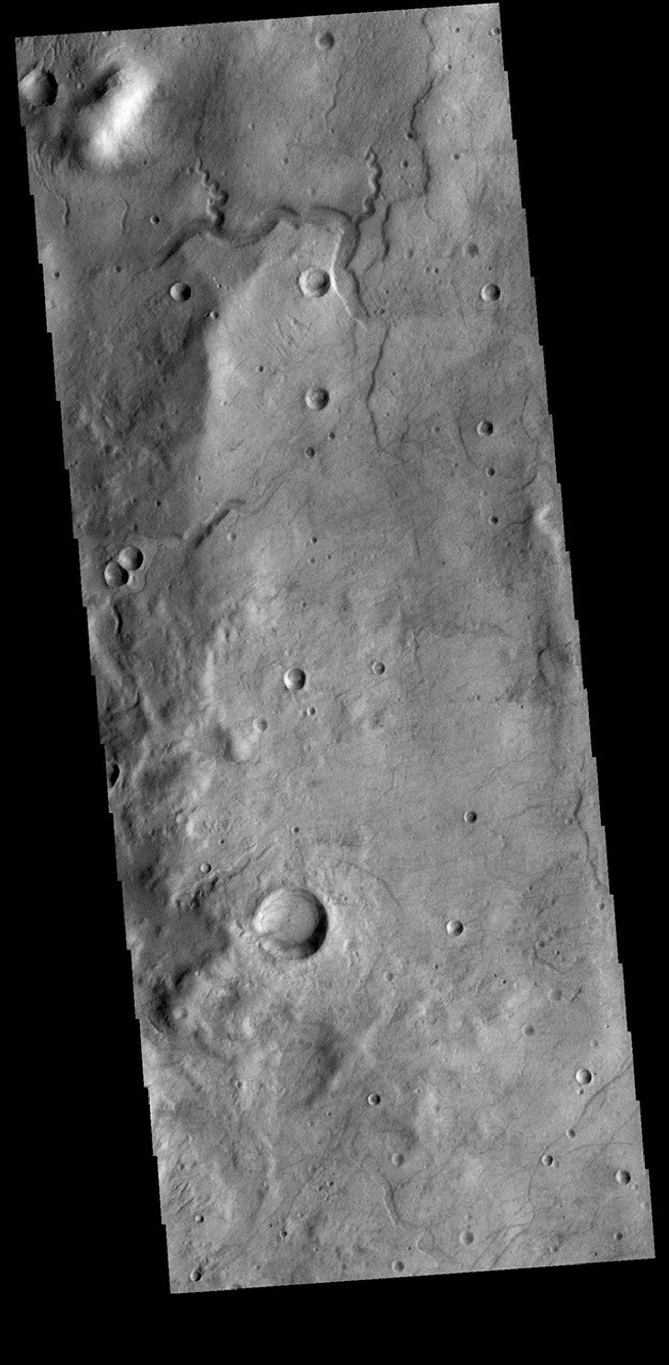 This image from NASA's Mars Odyssey shows a small channel system dissecting the rim of this unnamed crater in Terra Sirenum.