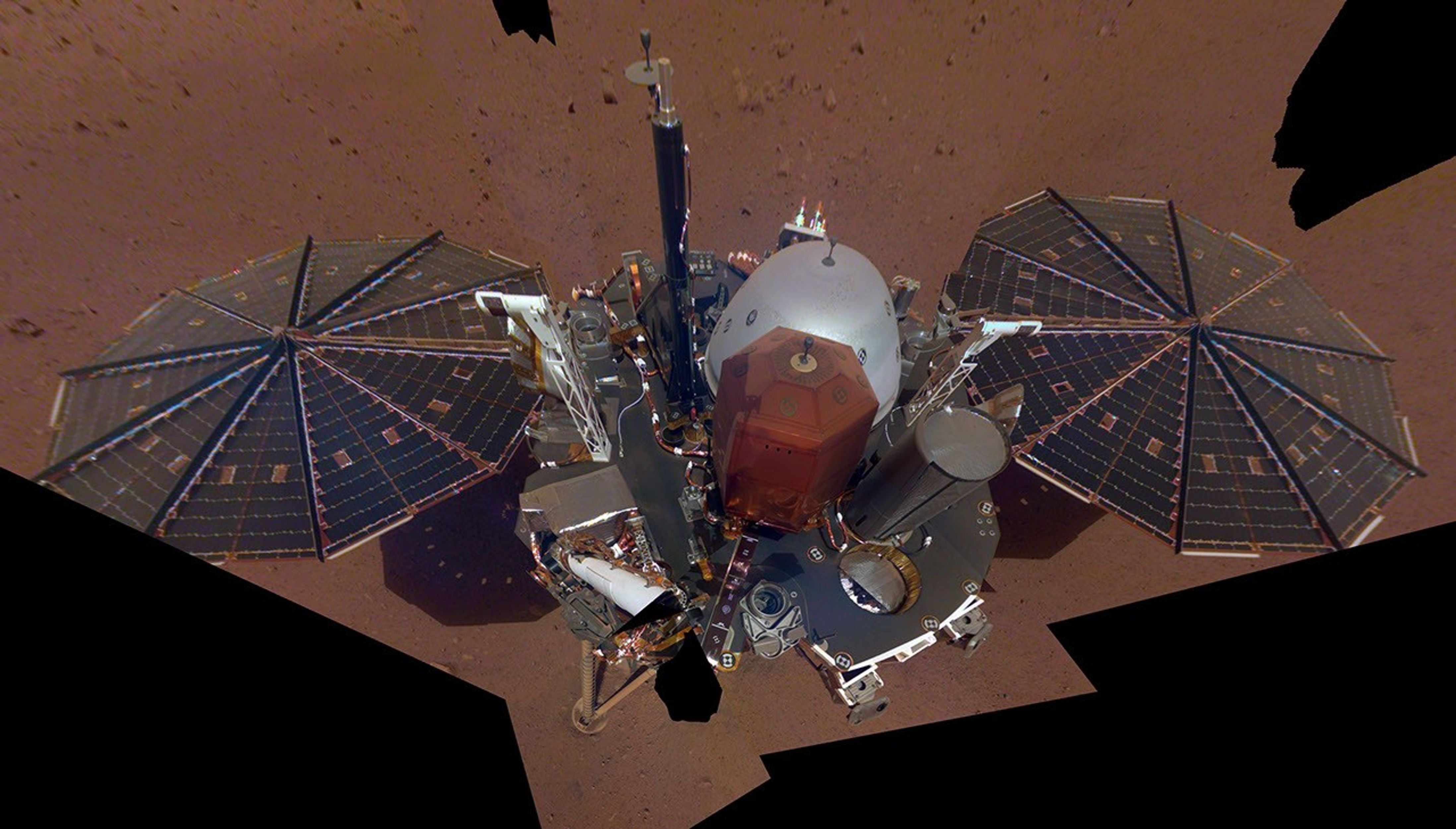 This is NASA InSight's first selfie on Mars. It displays the lander's solar panels and deck. On top of the deck are its science instruments, weather sensor booms and UHF antenna.