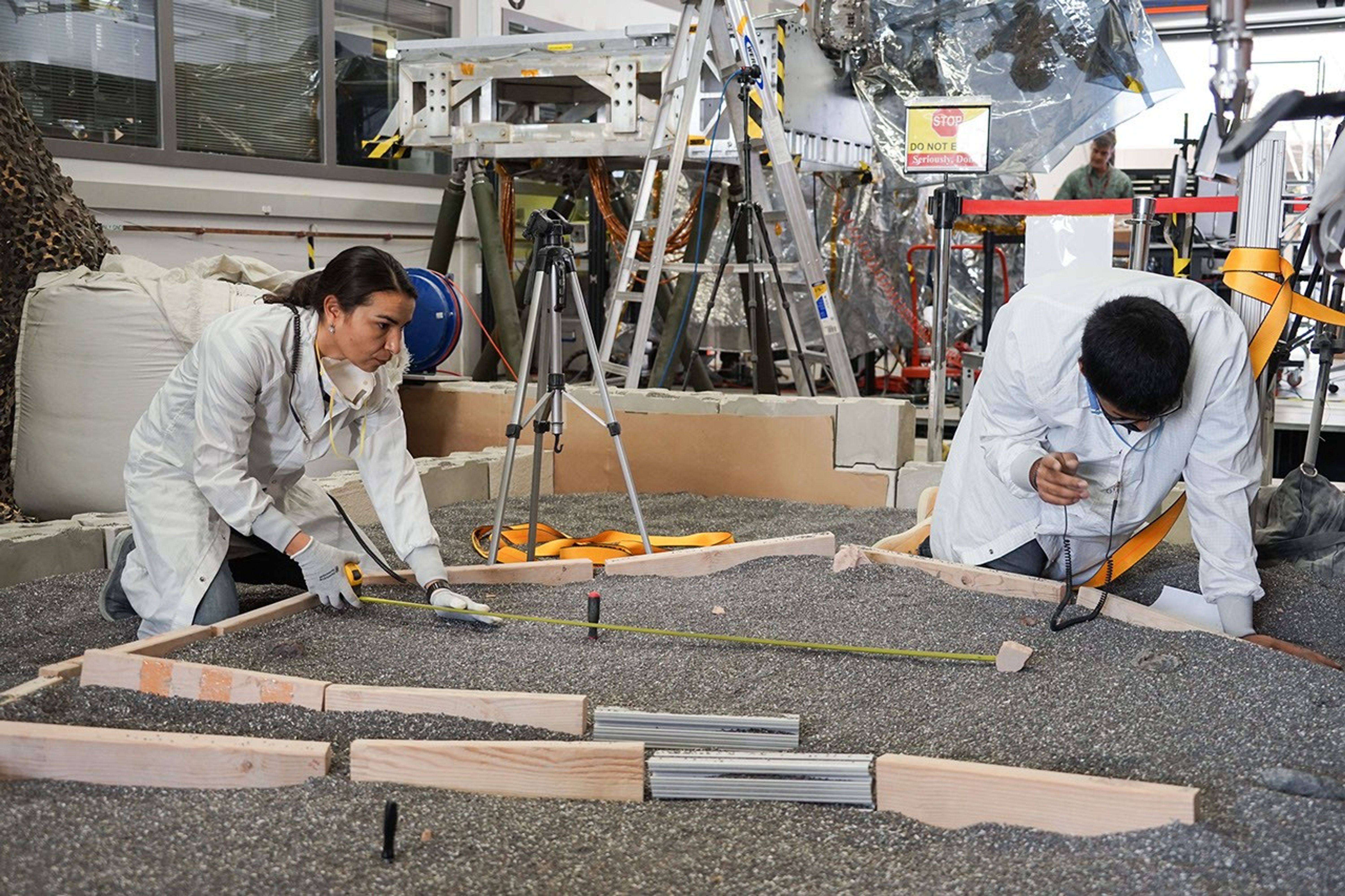 Engineers measure their test lander's 'workspace' -- the terrain where scientists want to set InSight's instruments -- at NASA's Jet Propulsion Laboratory in Pasadena, California.