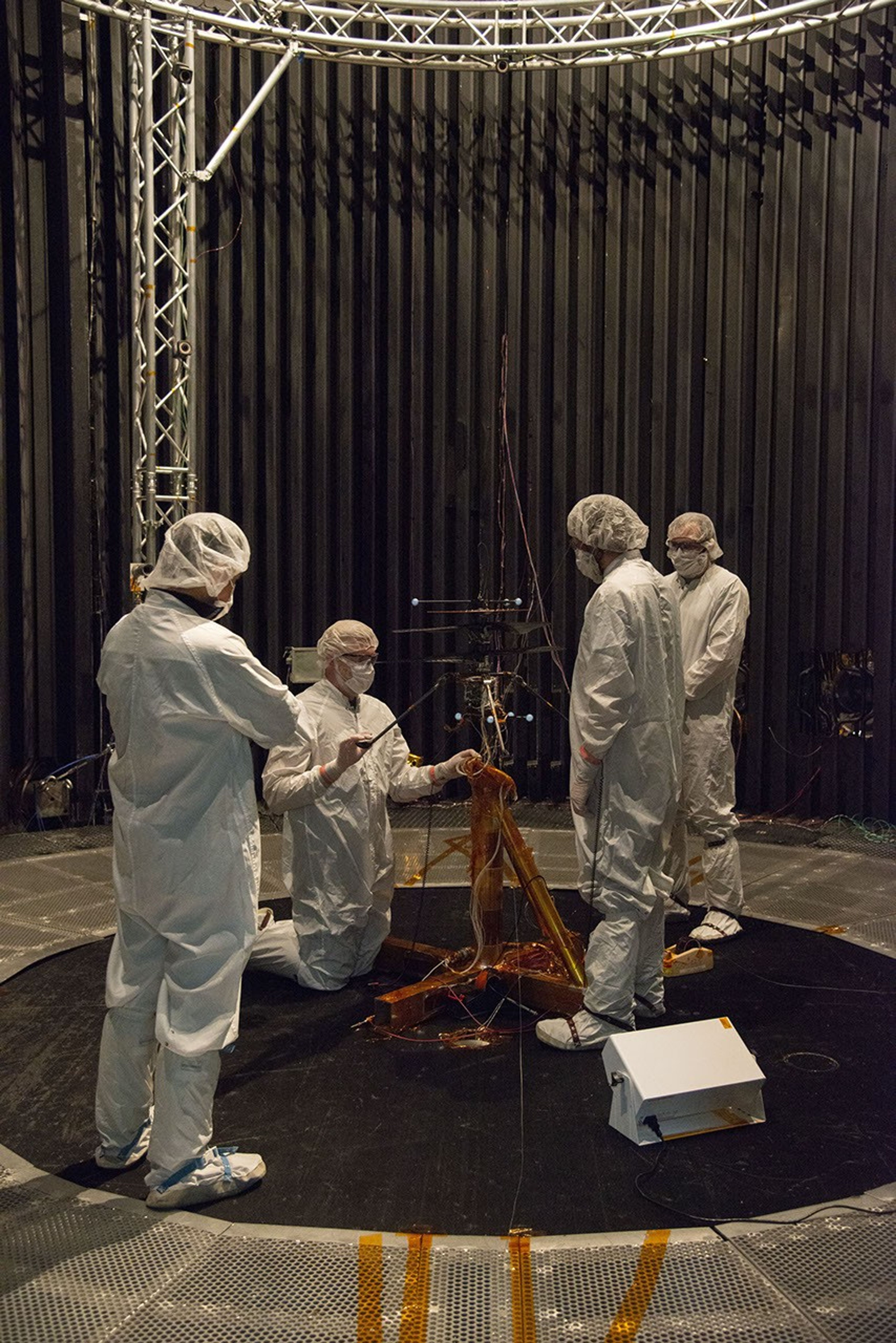 Members of NASA's Mars Helicopter team prepare the flight model for a test in the Space Simulator at NASA's Jet Propulsion Laboratory in Pasadena, California.