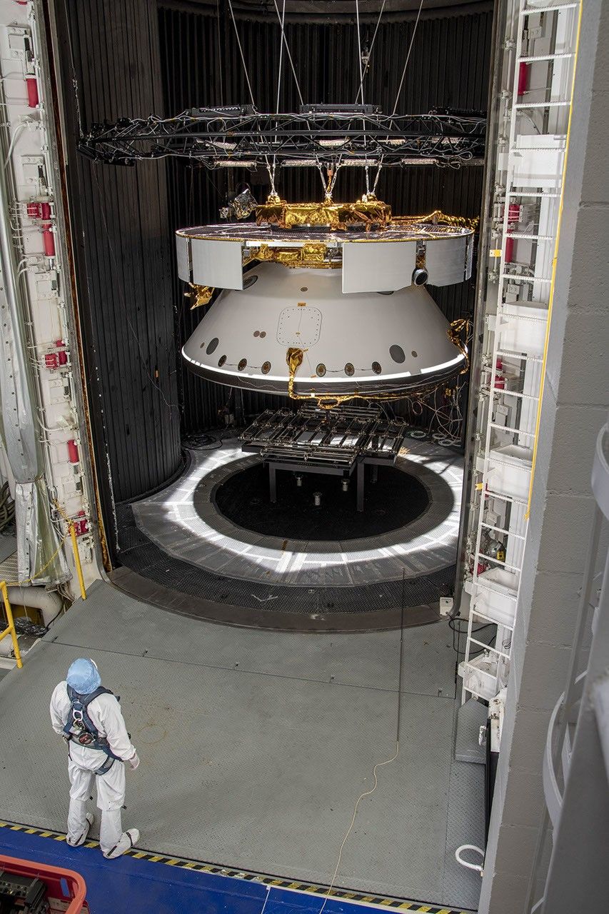 An engineer inspects the completed spacecraft that will carry NASA's next Mars rover to the Red Planet, prior to a test in the Space Simulator Facility at NASA's Jet Propulsion Laboratory in Pasadena, California.