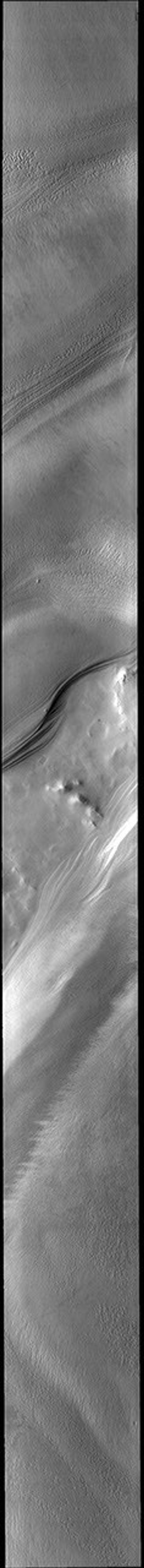 This image from NASA's Mars Odyssey shows part of the South Pole. The layers that comprise the polar cap are visible along the sides of the chasma.