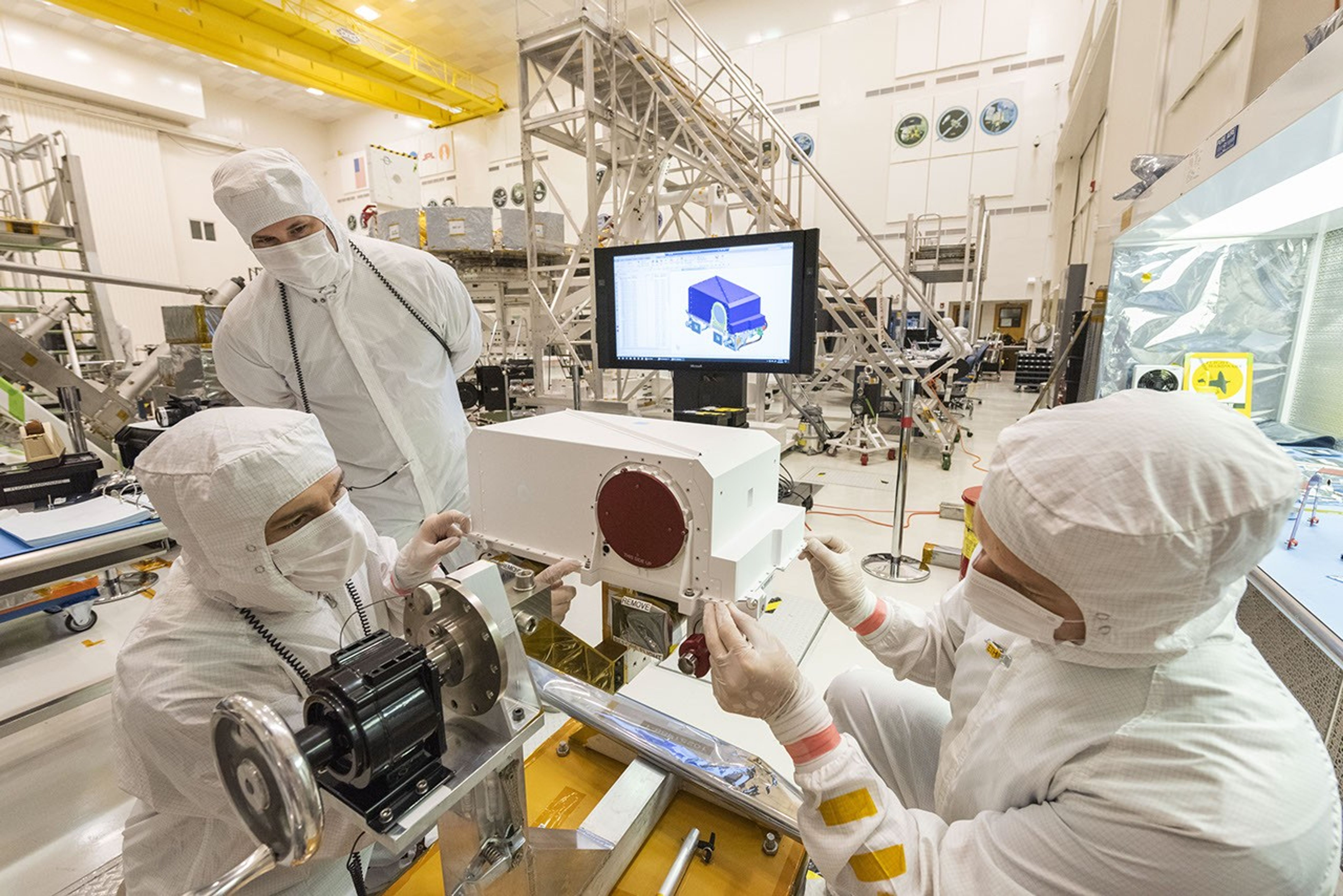 Engineers re-install the cover to the remote sensing mast (RSM) head after integration of two Mastcam-Z high-definition cameras that will go on NASA's Mars 2020 rover.