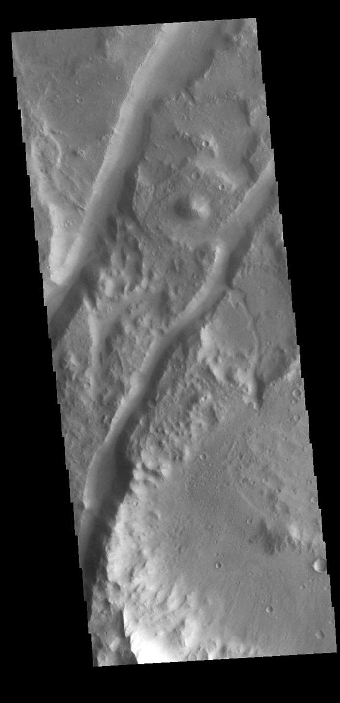 This image from NASA's Mars Odyssey shows two linear depressions, graben, created by tectonic activity.