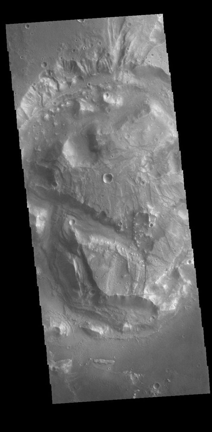 This image from NASA's Mars Odyssey shows a complex block of material located on the floor of an unnamed crater in Arabia Terra.