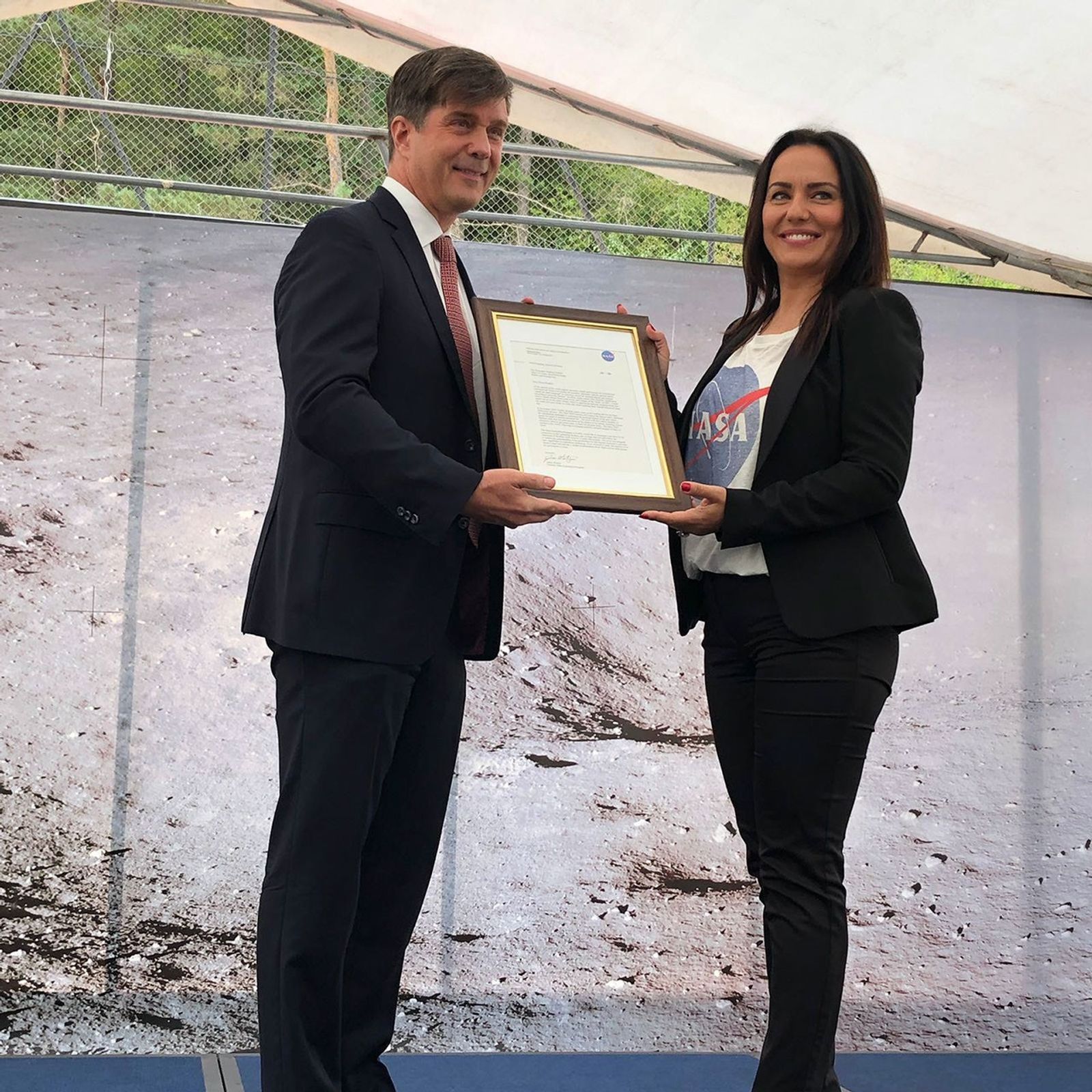 The U.S. Ambassador to Bosnia and Herzegovina, presents a framed letter to the mayor of the Balkan municipality of Jezero.