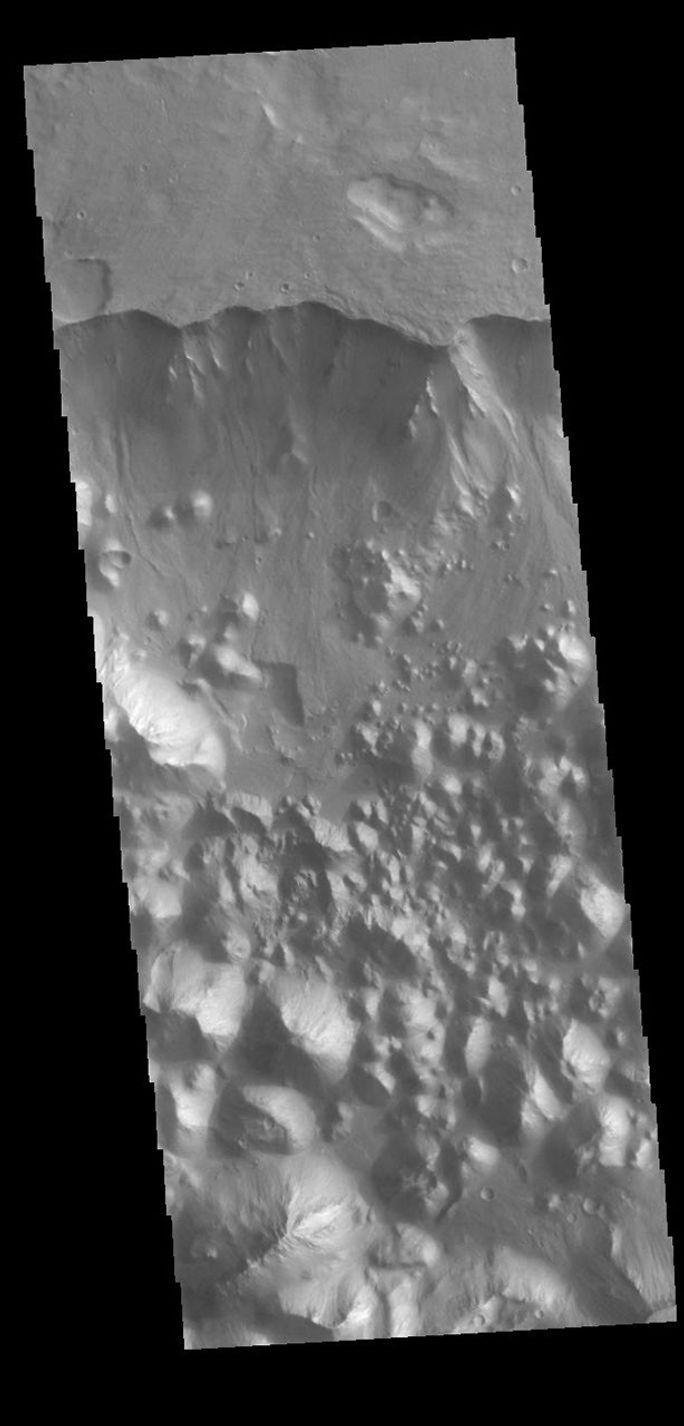 This image from NASA's Mars Odyssey shows part of Aronatum Chaos. Aromatum Chaos is a depression about 90 km (56 mi) long by 30 km (20 mi) wide.