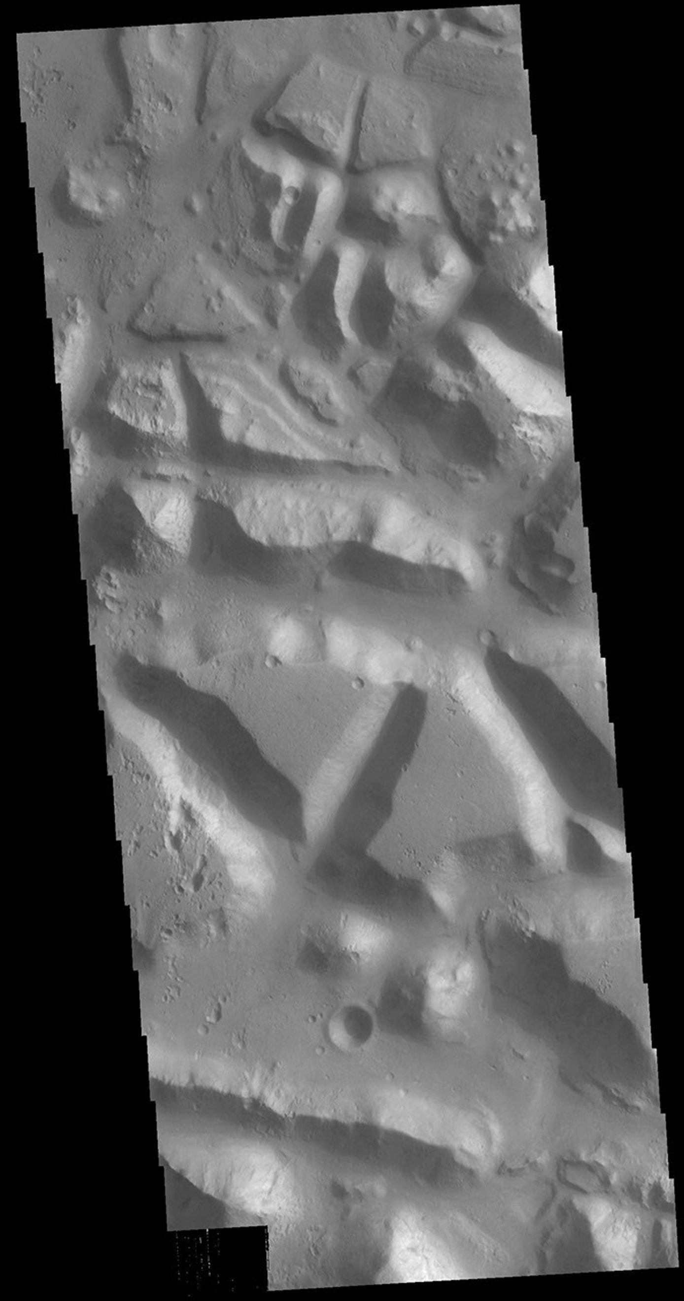 This image from NASA's Mars Odyssey shows huge regions of complex valleys and chaos, located in Xanthe and Margaritifer Terras.