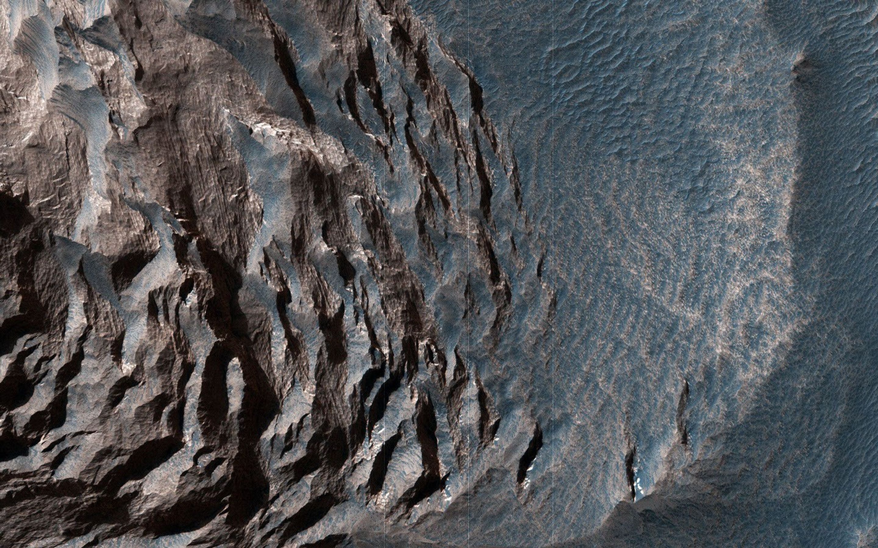 This image acquired on August 8, 2019 by NASA's Mars Reconnaissance Orbiter, shows layered sediments on the floor of eastern Coprates Chasma in Valles Marineris, the grandest canyon on Mars.