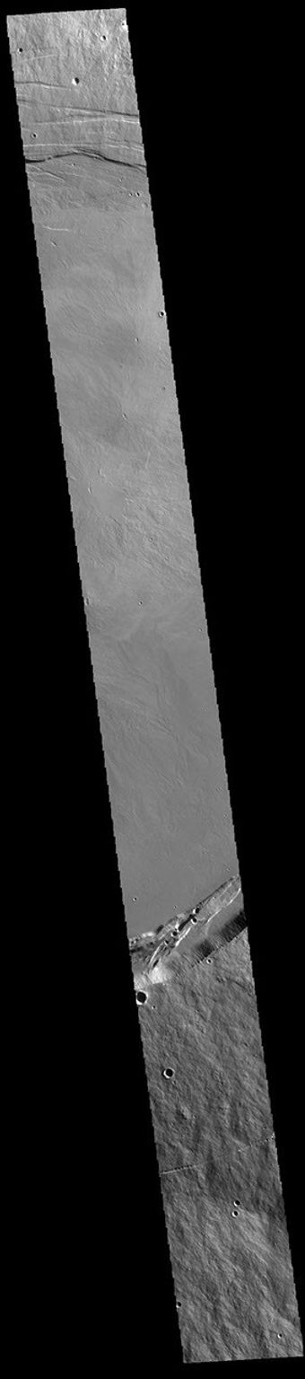 This image from NASA's Mars Odyssey shows a large volcanic crater, known as a caldera, located at the summit of all of the Tharsis volcanoes.