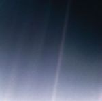 Earth as a tiny bluish dot suspended in a grainy beam of light., a speck in the vast emptiness that fills the rest of the frame.