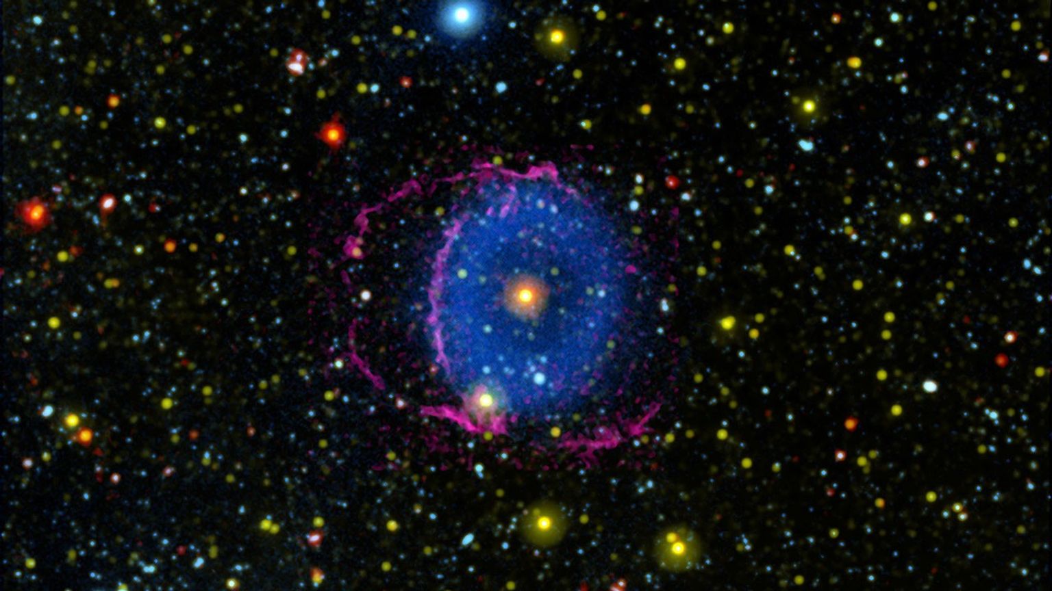 The Blue Ring Nebula consists of two expanding cones of gas ejected into space by a stellar merger. As the gas cools, it forms hydrogen molecules that collide with particles in interstellar space, causing them to radiate far-ultraviolet light.