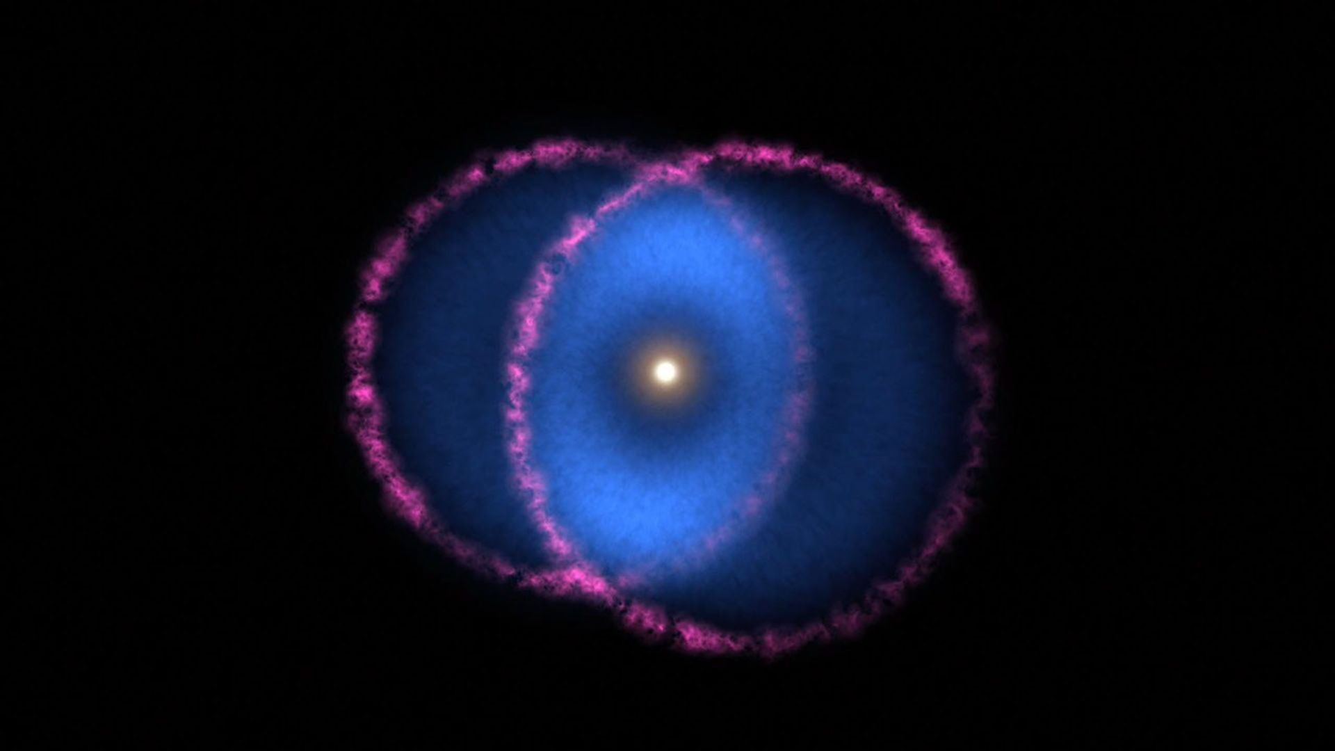 The Blue Ring Nebula consists of two expanding cones of debris. The base of one cone is moving toward Earth. Both bases are outlined in magenta, revealing shockwaves created as the debris races through space.