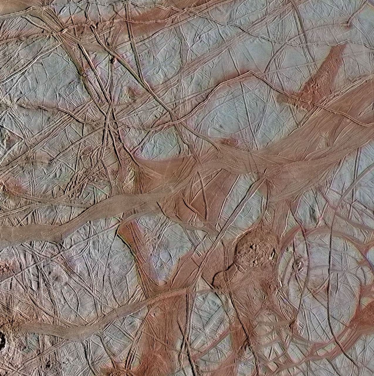 The surface of Jupiter's moon Europa features a widely varied landscape, including ridges, bands, small rounded domes and disrupted spaces that geologists called chaos terrain.