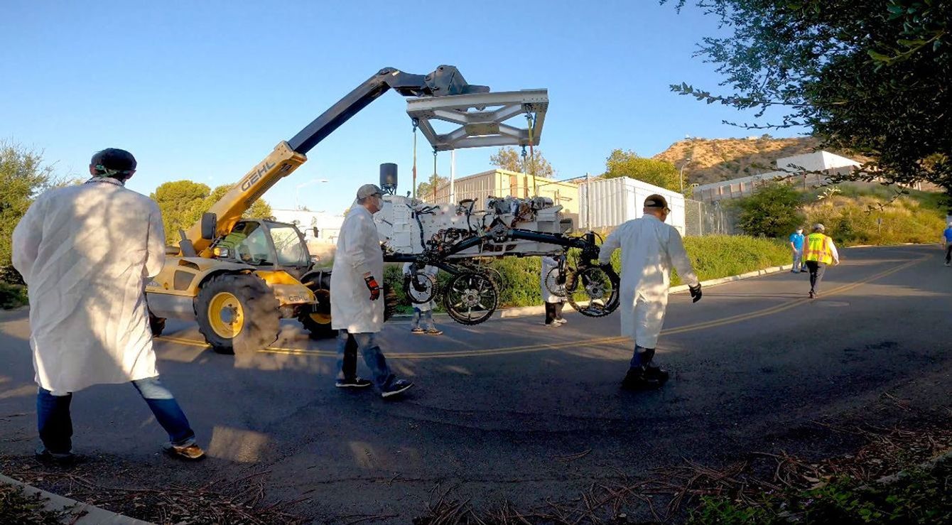 Technicians move an engineering version of the Perseverance Mars rover into to its new home in the Mars Yard, part of NASA's Jet Propulsion Laboratory in Southern California.