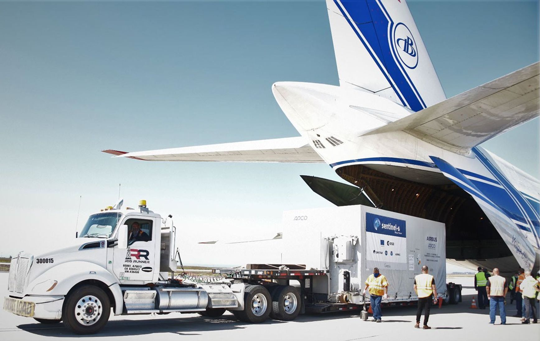 A shipping container containing the Sentinel-6 Michael Freilich satellite is transported on a truck to the SpaceX payload processing facility at Vandenberg Air Force Base after landing in California on Sept. 24, 2020.