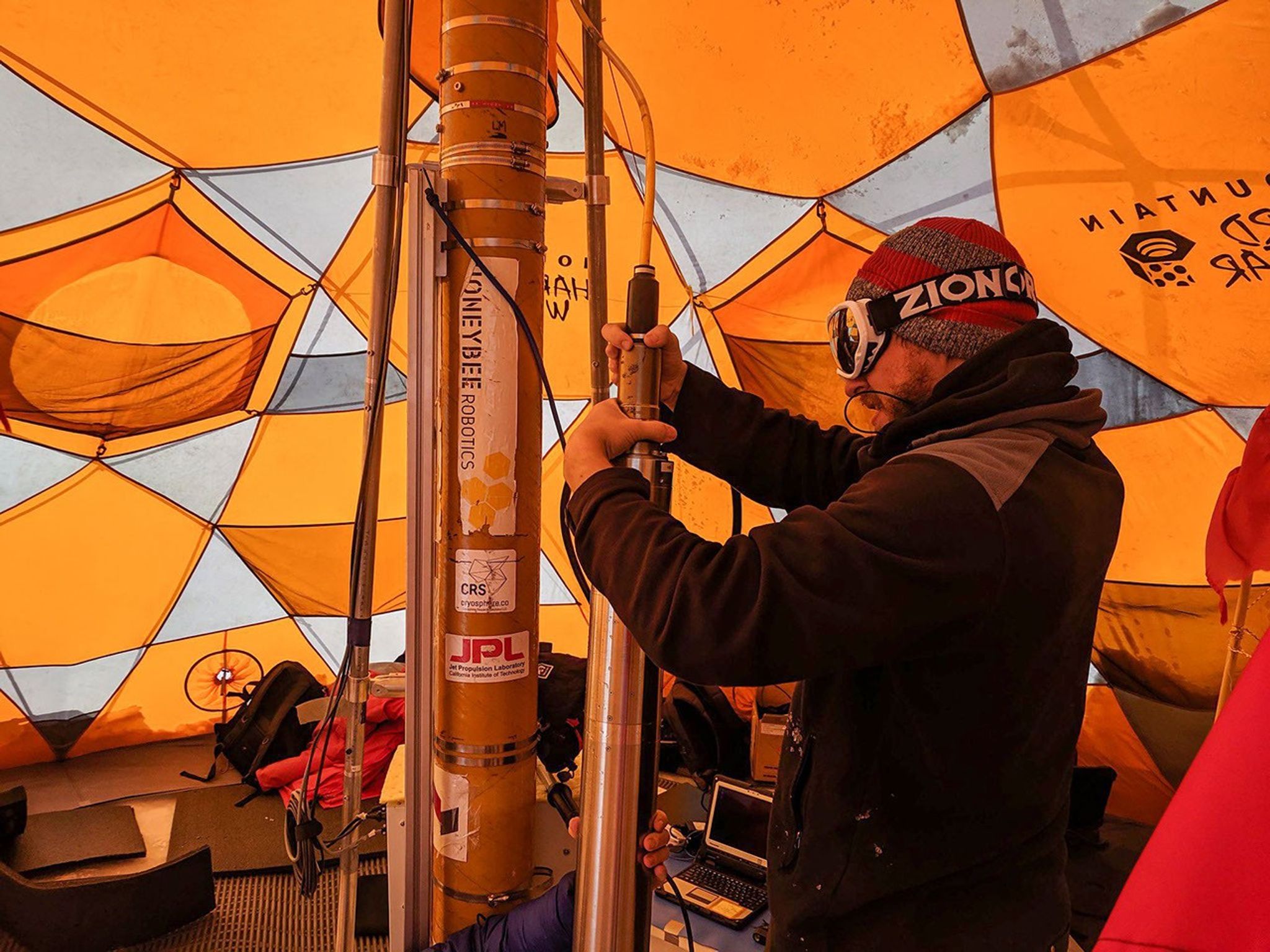 The tether attached to the top of WATSON and the drill also acts as the power cable and data feed. Care must be taken to ensure a tight connection between the tether and instrument, else the instrument could be lost in the ice.