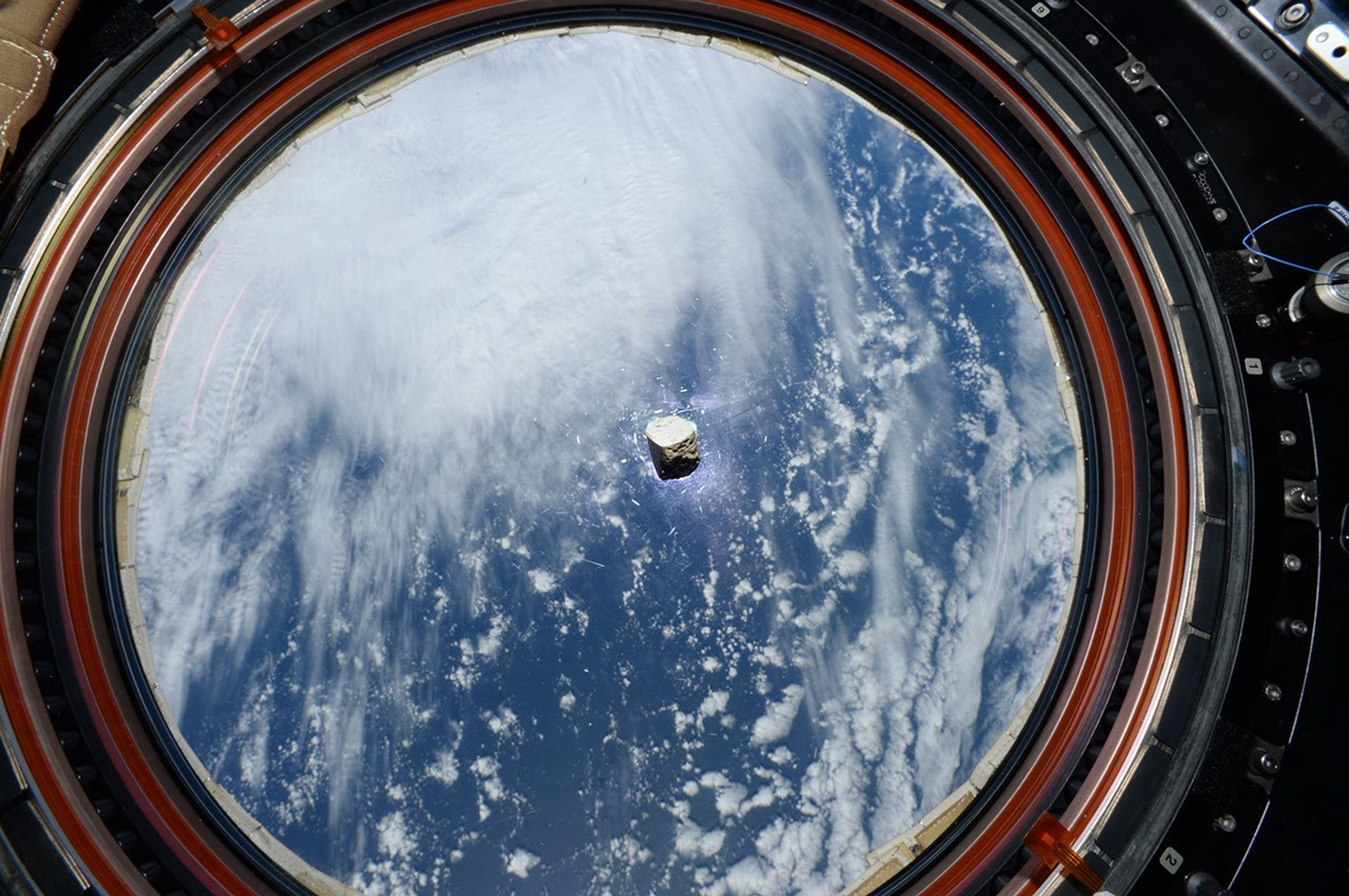 This fragment of a Martian meteorite, seen floating inside the International Space Station, is is now part of a calibration target for SuperCam, one of the instruments aboard NASA's Perseverance Mars rover.