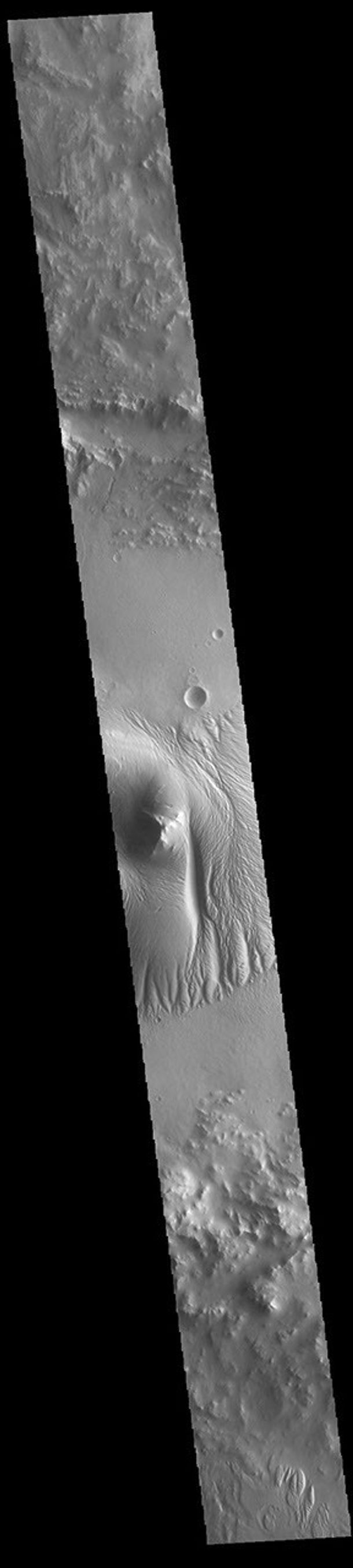 This image from NASA's Mars Odyssey shows a cross section of Nicholson Crater. The central peak of this crater is surrounded by a layered deposit that rises 3.5km (2 miles) above the crater floor.