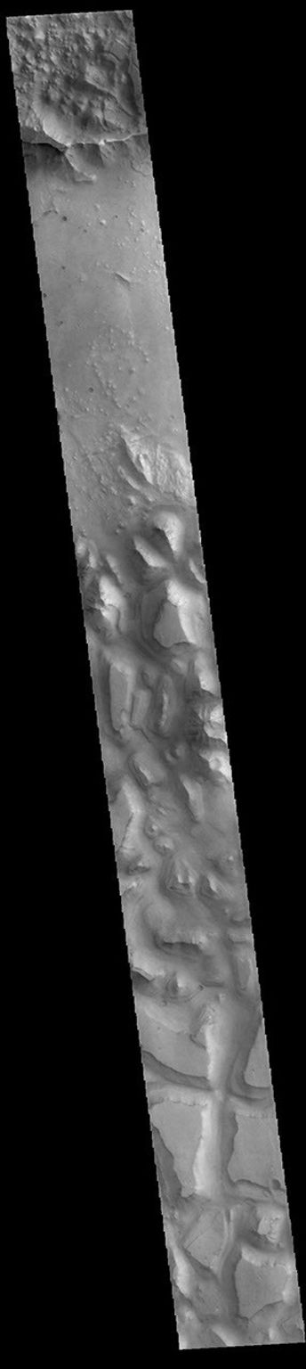 This image from NASA's Mars Odyssey shows part of Hydraotes Chaos. The chaos lies in a valley leading northeast out of Ganges Chasma at the east end of Valles Marineris.