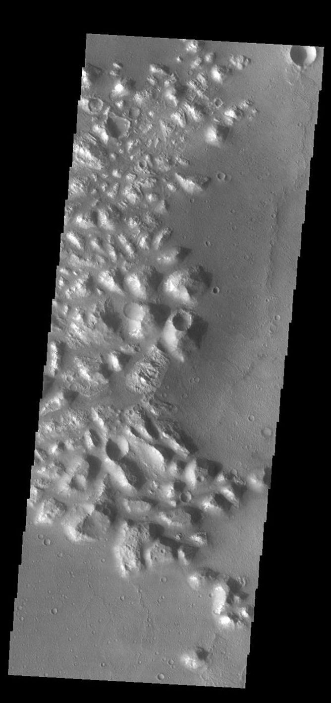 This image from NASA's Mars Odyssey shows part of Atlantis Chaos. Chaos terrain is typified by regions of blocky, often steep sided, mesas interspersed with deep valleys.