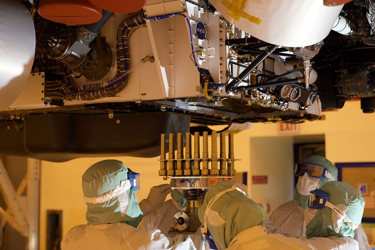 A tray holding 39 sample tubes, each protected in a gold-colored sheath, is installed in NASA's Perseverance rover in this picture taken at the agency's Kennedy Space Center on May 21, 2020.