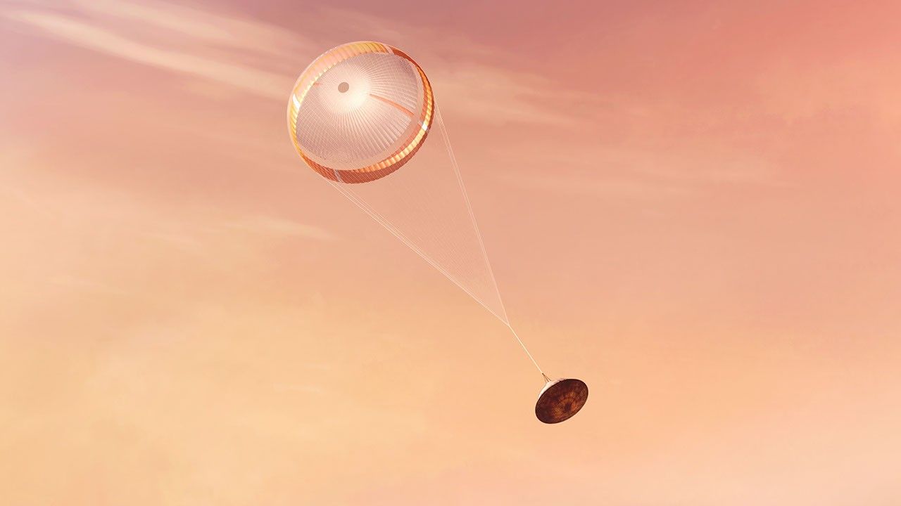 NASA's Perseverance rover deploys a supersonic parachute from its aeroshell as it slows down before landing, in this artist's illustration.