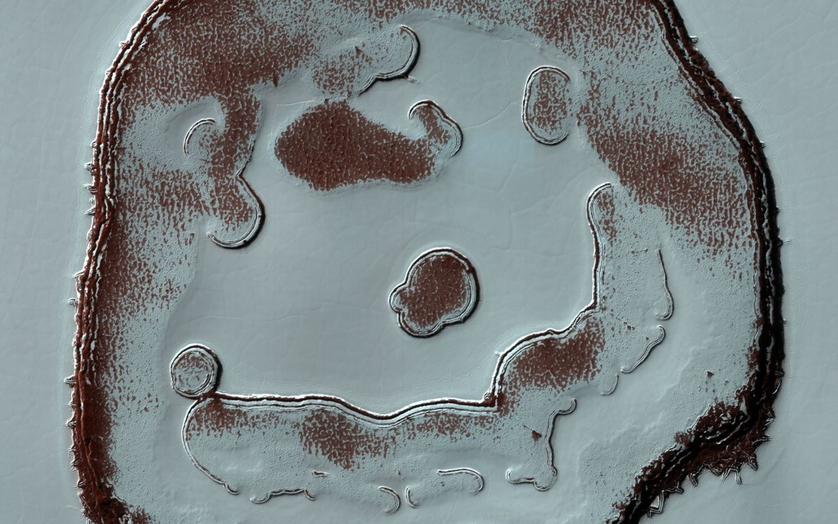 This image acquired on December 13, 2020 by NASA's Mars Reconnaissance Orbiter, shows blobby features in the polar cap that are due to the sun sublimating away the carbon dioxide into these round patterns.