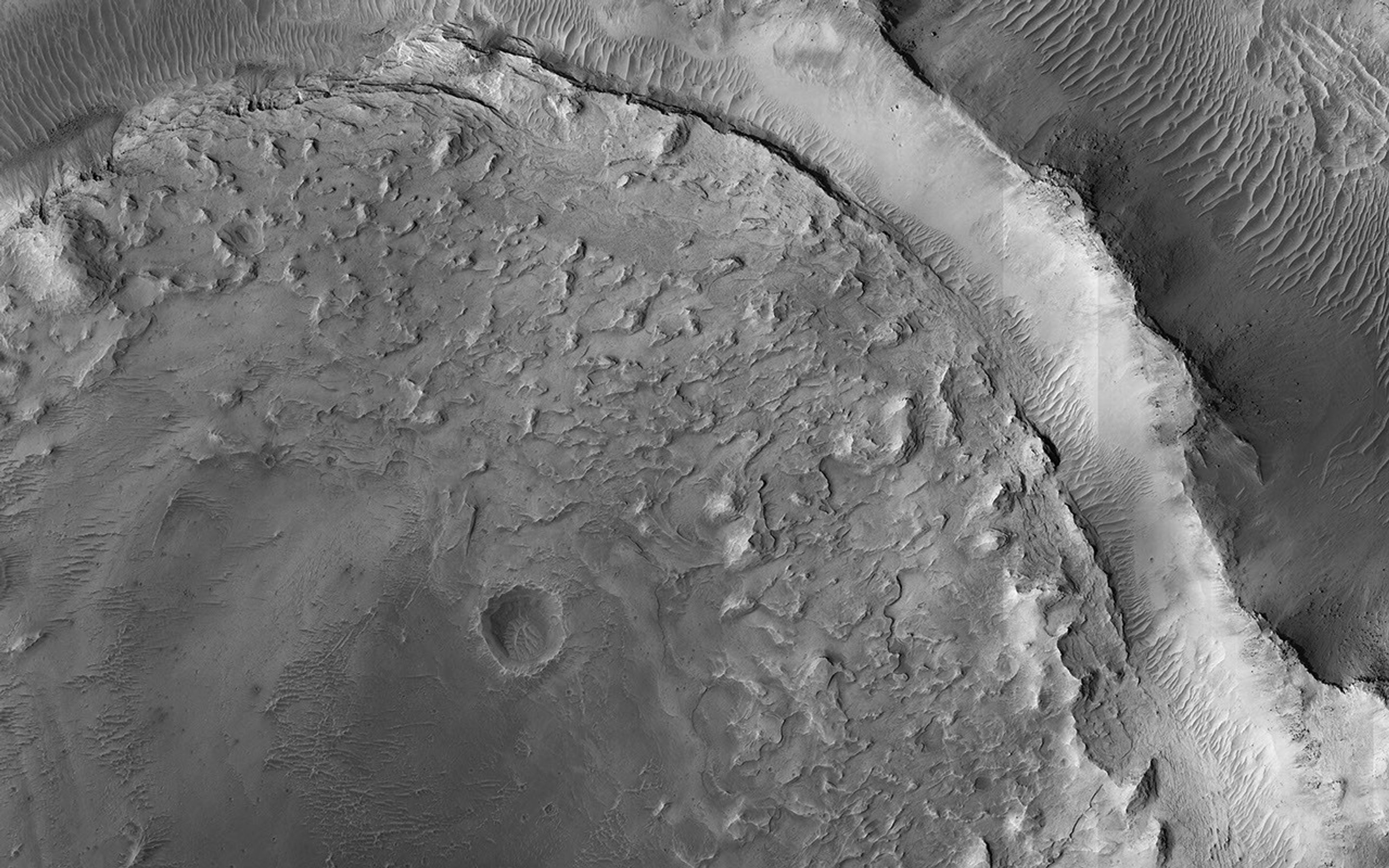 This image acquired on January 3, 2021 by NASA's Mars Reconnaissance Orbiter, shows evidence of a complex cycle of cratering and erosion.