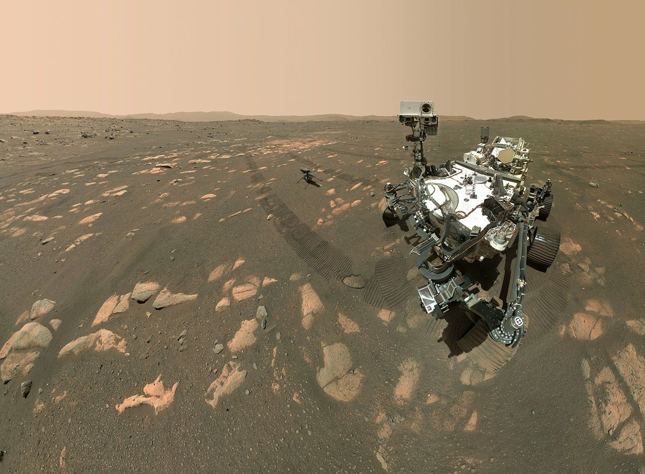 NASA's Perseverance Mars rover took a selfie with the Ingenuity helicopter, seen here about 13 feet (3.9 meters) from the rover. This image was taken by the WATSON camera on the rover's robotic arm on April 6, 2021.