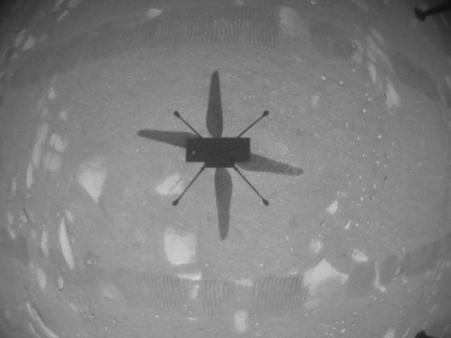NASA's Ingenuity Mars Helicopter took this shot, capturing its own shadow, while hovering over the Martian surface on April 19, 2021, during the first instance of powered, controlled flight on another planet.